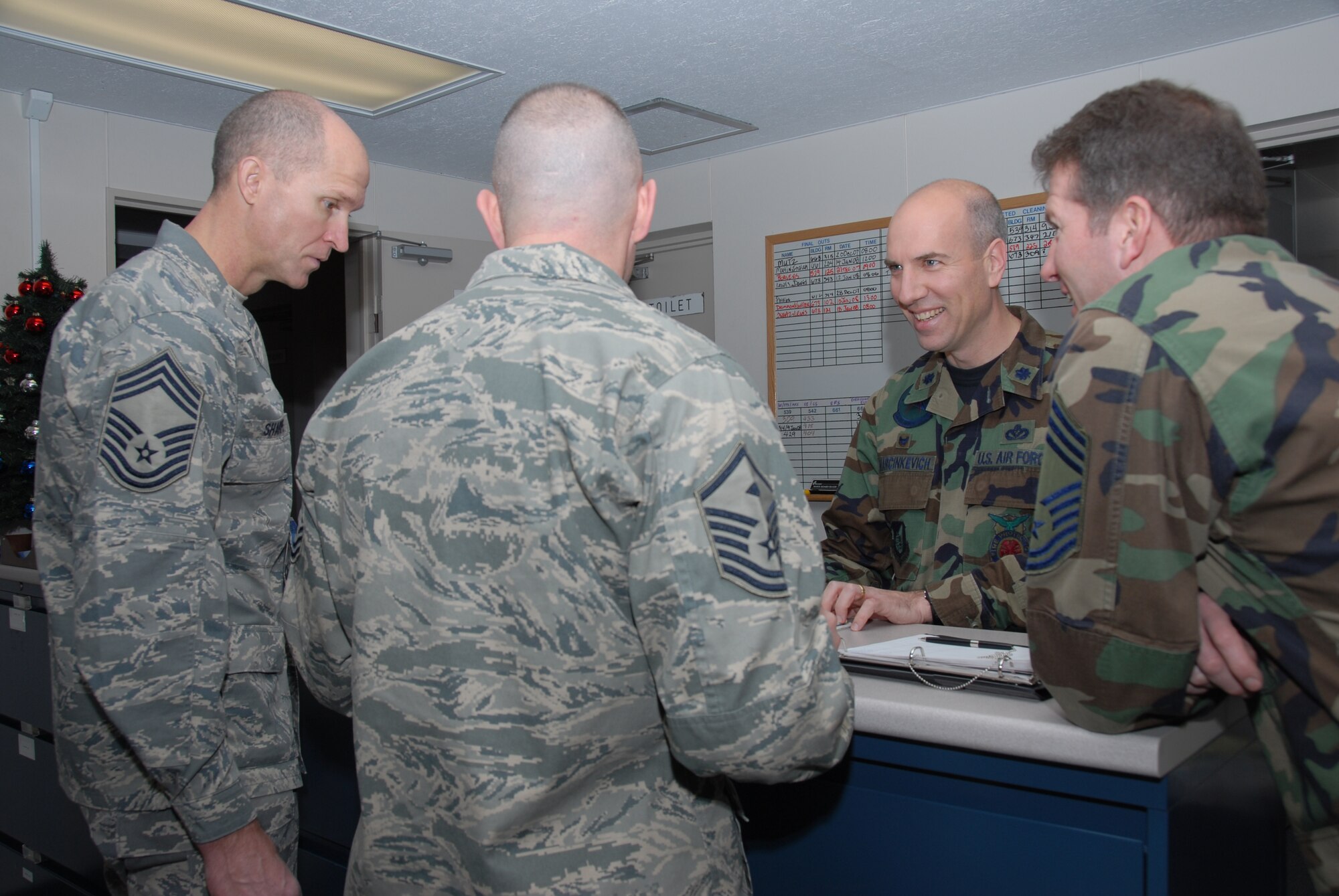 MISAWA AIR BASE, Japan -- Lt. Col. Joseph Marcinkevich, 35th Civil Engineer Squadron commander, and several other members of the 35th Civil Engineer Squadron, make their final decision after evaluating several CE dorm doors for a door decorating contest here Dec. 26, 2007.  (U.S. Air Force photo by Senior Airman Laura R. McFarlane)
