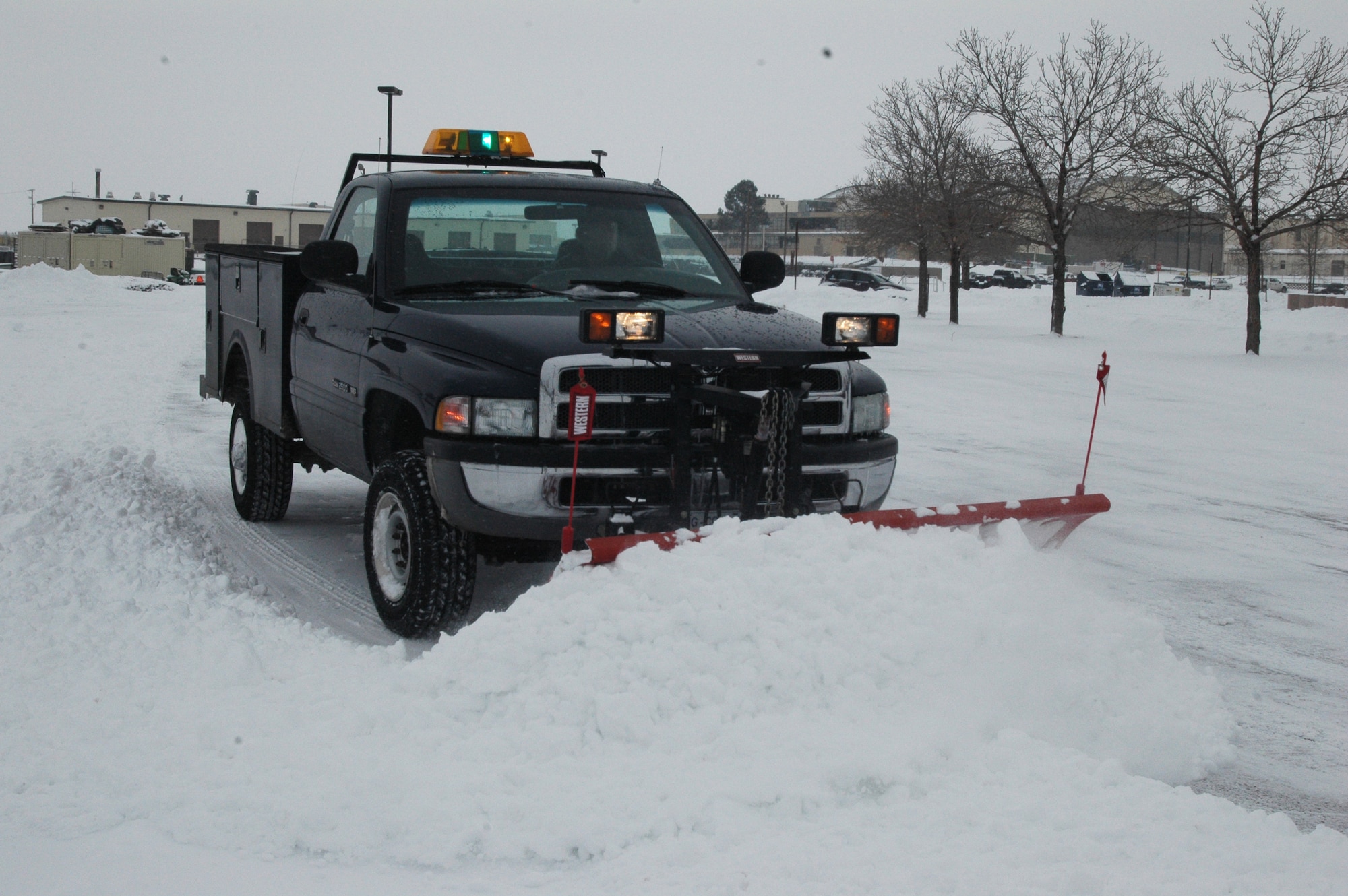 Mr. Tom Sorrell, from the 140th Civil Engineer Squadron, pushes snow to the sides of the parking lot at the 140th Wing headquarters building at Buckley Air Force Base Dec. 27. (U.S. Air Force photo by Capt. Adrianne Michele)