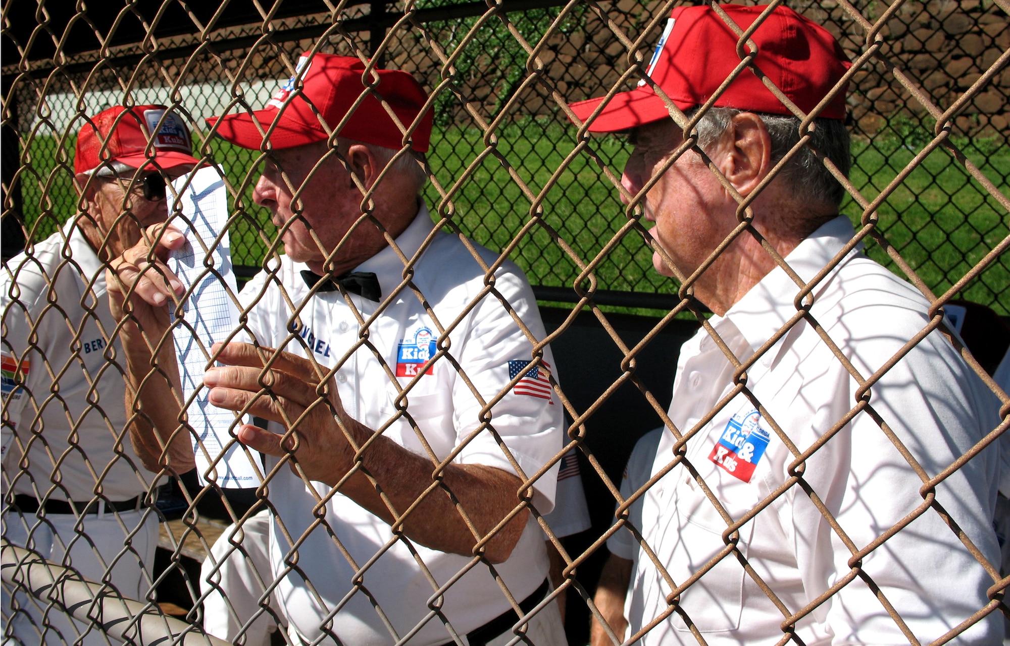 Winchell Smith, 88, and Andy Devine, 82, both members of the Kids & Kubs senior softball team from St. Petersburg, Fla., discuss their team's batting order before their game against the Over the Rainbows senior softball team from Japan Dec. 19 at Hans L'Orange Park in Waipahu, Hawaii. The two teams, comprising WWII veterans, met here to make peace with the past and play this historic game. The Kids & Kubs won the game 14-2. (U.S. Air Force photo/Tech. Sgt. Chris Vadnais)