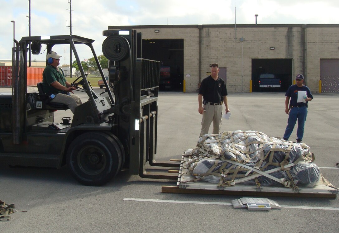 FBI Miami Rapid Deployment Team agents prepare equipment to be airlifted on an exercise with Homestead Air Reserve Base Fire and Emergency Services members for a simulated overseas deployment on Nov. 28-29. The RDT, based out of Homestead ARB, is comprised of many response teams specializing in areas such as hazardous materials, evidence collection and special weapons and tactics. Teams deploy overseas to support FBI missions, which may include anything from terrorist activity to criminal activity against U.S. interests abroad. (Courtesy photo)