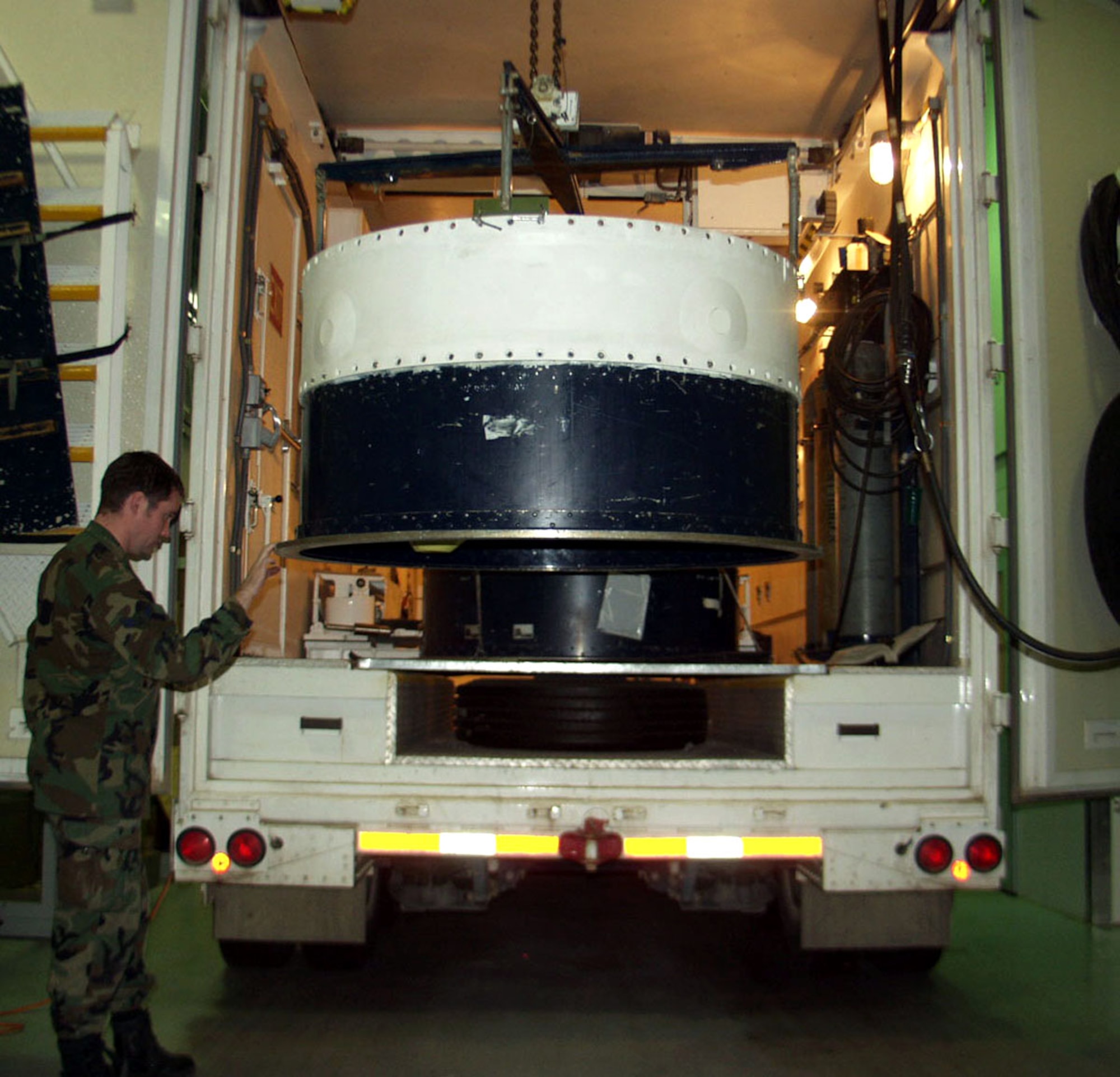 Senior Airman Clayton Creamer inspects the NS-20 guidance set as it comes out of the payload transporter Dec. 4 at Malmstrom Air Force Base, Mont. Base Airmen completed replacing the NS-20 missile guidiance set with the new NS-50. Airman Creamer is a 341st Missile Maintenance Squadron top side technician. (U.S. Air Force photo/Master Sgt. Maxwell Jackson) 
