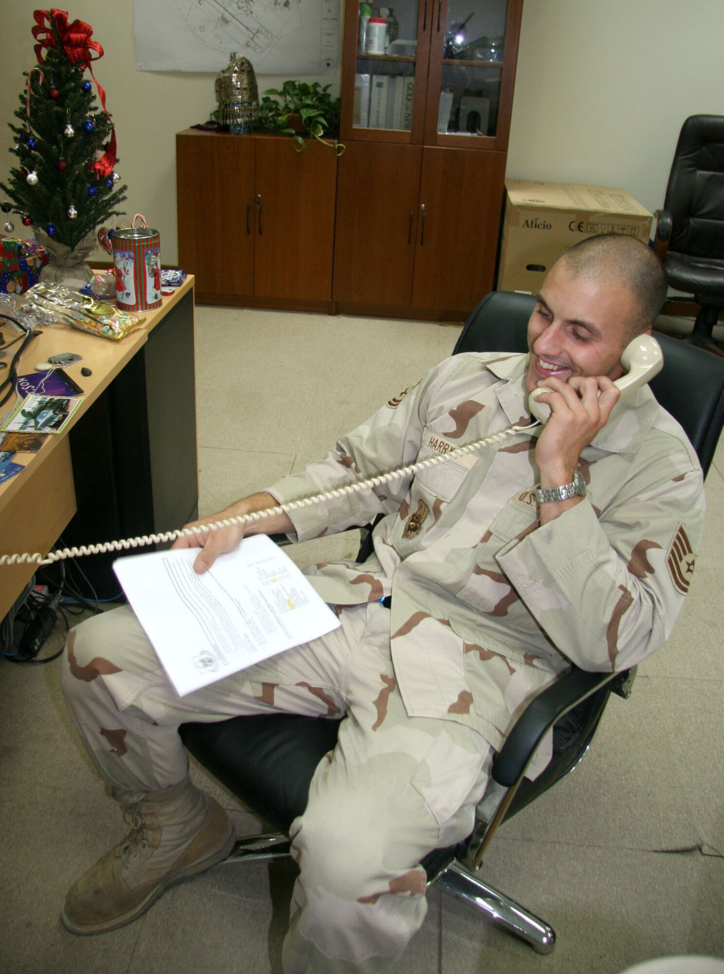 Tech. Sgt. Christopher Harry, deployed to Southwest Asia over the holidays, shares cheerful conversation on Christmas Eve during a conference call with his family. Sergeant Harry is an Air Force Reserve Command aerial port technician who has been deployed since September. (US Air Force photo/Master Sgt. Ruby Zarzyczny)
