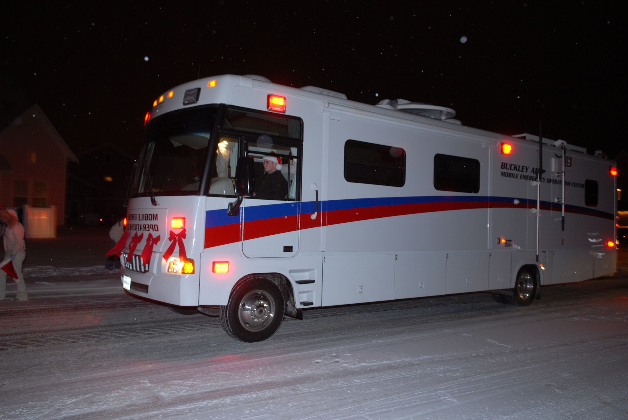 The Mobile Emergency Operations Center drives through Buckley's base housing for the base's holiday parade Dec. 21. (U.S. Air Force photo by Staff Sgt. Dallas Edwards)