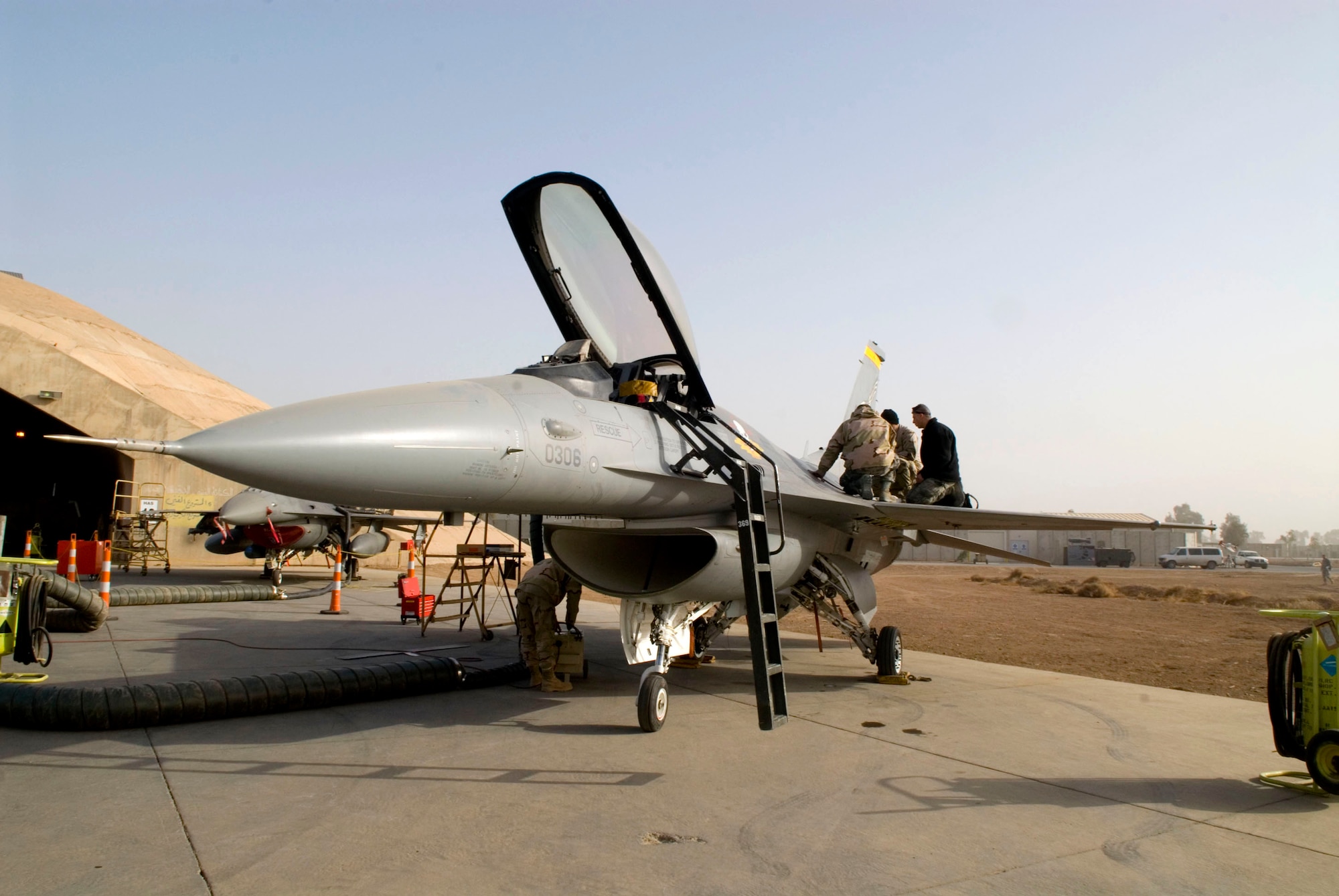 Members of the 332nd Expeditionary Maintenance Squadron's Sheet Metal Flight perform maintenance on an F-16 Fighting Falcon Dec. 22 at Balad Air Base, Iraq. When leaks are found on the aircraft, it is up to the sheet metal flight members to reseal damaged areas. (U.S. Air Force photo/Staff Sgt. Joshua Garcia) 
