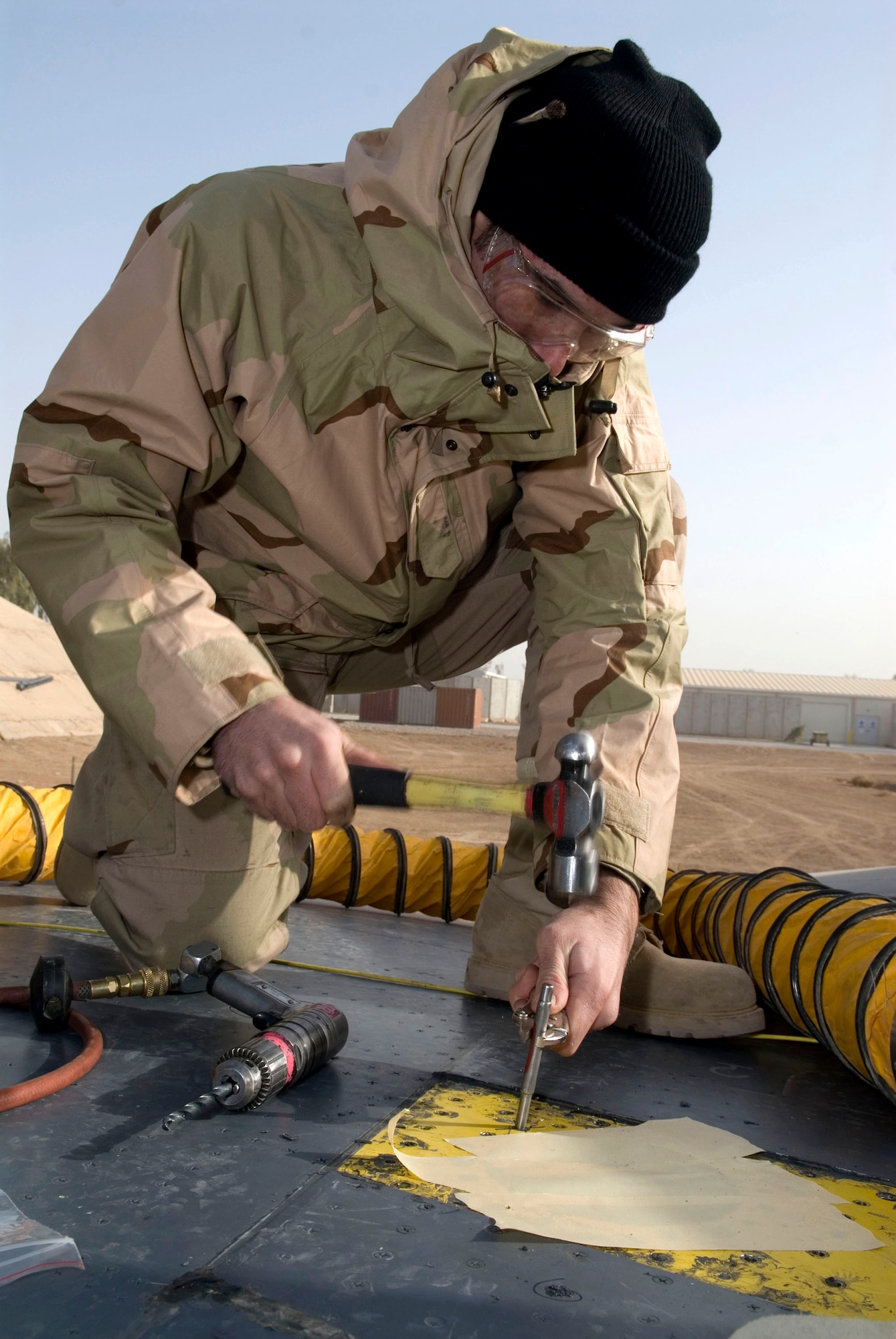 Airman 1st Class Bradley Giroux hammers out a faulty nut on an F-16 Fighting Falcon's Davis Elliptical fastener Dec. 22 at Balad Air Base, Iraq. The fastener is a self-locking, self-sustaining device that holds multiple bolts in place. Airman Giroux, a 332nd Expeditionary Maintenance Squadron sheet metal technician, is deployed from Spangdahlem Air Base, Germany. (U.S. Air Force photo/Staff Sgt. Joshua Garcia) 
