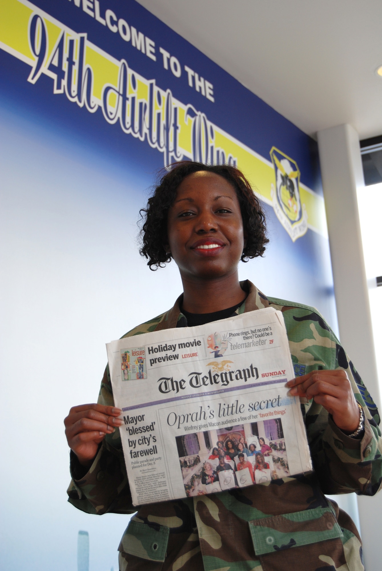 It's an Oprah fan's dream to score a ticket to "The Oprah Winfrey Show," especially when it's for the taping of the Thanksgiving giveaway show called "Oprah's Favorite Things." The dream came true for financial technician, Staff Sgt. Rena Christian of the 94th Airlift Wing's Financial Management office, (shown holding a copy of the Macon Telegraph). She was given a ticket to the November taping of Oprah's show in Macon, Ga. Sergeant Christian and the rest of Oprah's Macon fans walked away with Progressive HD Camcorder, Artisan stand-mixer, a Panini press and the most expensive gift ever given on "Oprah's Favorite Things" show: a top-of-the-line LG HDTV refrigerator. The stainless-steel appliance has an LCD TV, DVD hookups, a radio, a slideshow option for digital photos, and it can display more than 100 built-in recipes at the push of a button. (Air Force photo/Master Sgt. Angelita Colon-Francia)