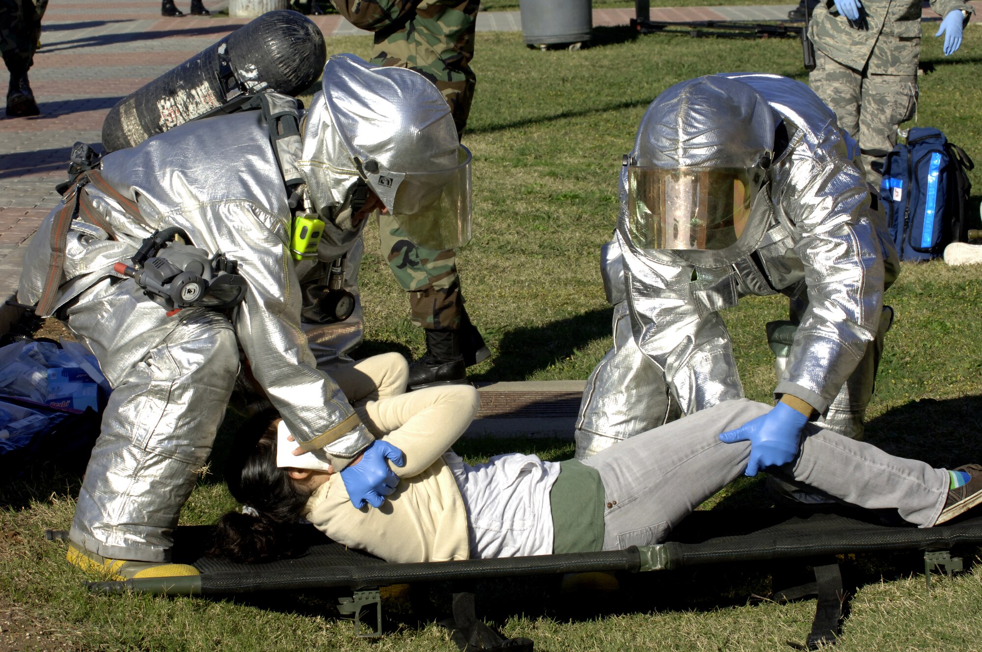 Members from the Incirlik Fire Department help move "injured" students into ambulances during the Mass Accident Response Exercise at the Incirlik Unit School Dec. 17. Ten students volunteered to play the role of victims helping response crews practice their skills. (U. S. Air Force photo by Airman 1st Class Nathan Lipscomb)