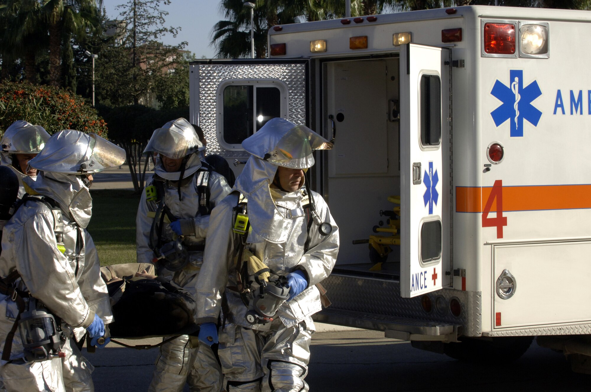 Members from the Incirlik Fire Department help load "injured" students into ambulances during a Mass Accident Response Exercise at the Incirlik Unit School Dec. 17. Ten students volunteered to play the role of victims helping response crews practice their skills. (U. S. Air Force photo by Airman 1st Class Nathan Lipscomb)