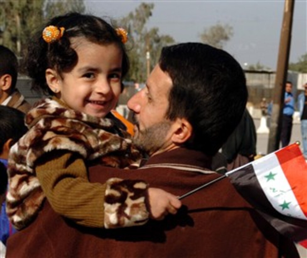 An Iraqi girl waves the flag of Iraq during a Peace March in the Karkh District of Baghdad, Dec. 19, 2007, as about 1,000 Iraqi citizens, both Shia and Sunni, march in unity.