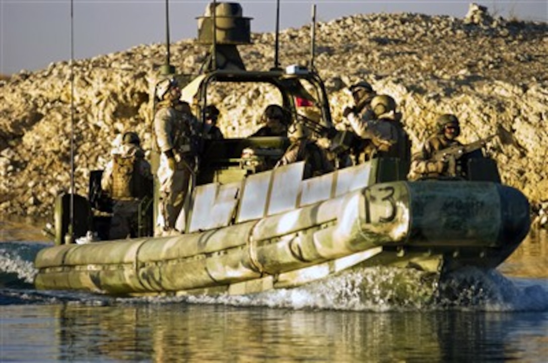 U.S. Navy sailors patrol the waterways of the Haditha Dam Forward Operating Base in Haditha, Iraq, in a riverine patrol boat on Dec. 20, 2007.  The sailors are attached to Riverine Squadron 2.  