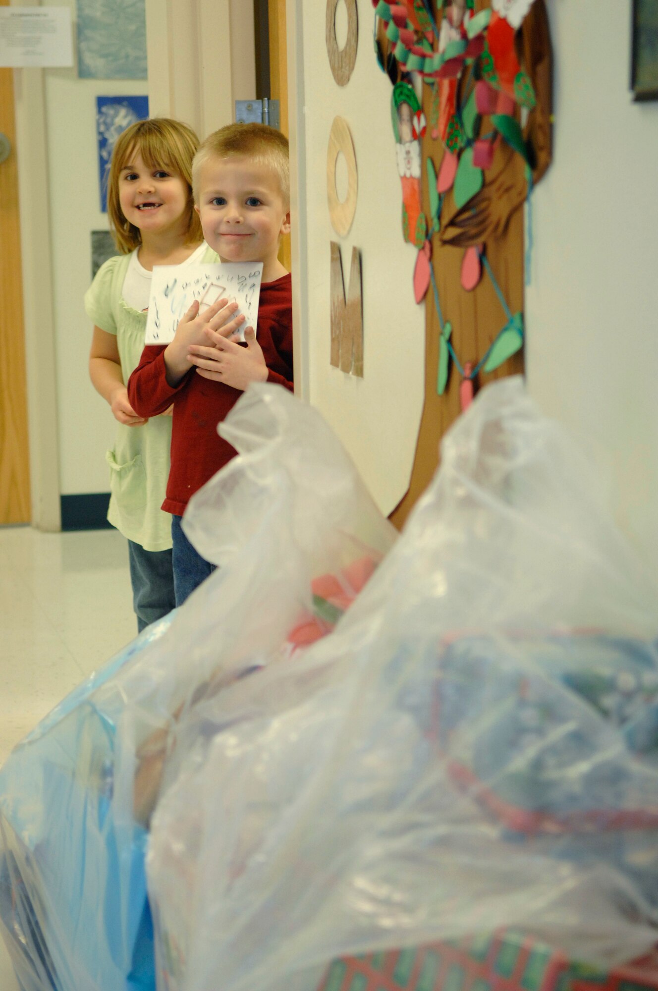 The Gryphon Unit Advisory Council of the 28th Operations Squadron sponsored an Angel Tree gift program for the Youth and Family Services Child Care center in Rapid City, S.D., Dec. 20. Students waited anxiously around every corner, trying to sneak a peek of when Santa Claus would bring their gift.