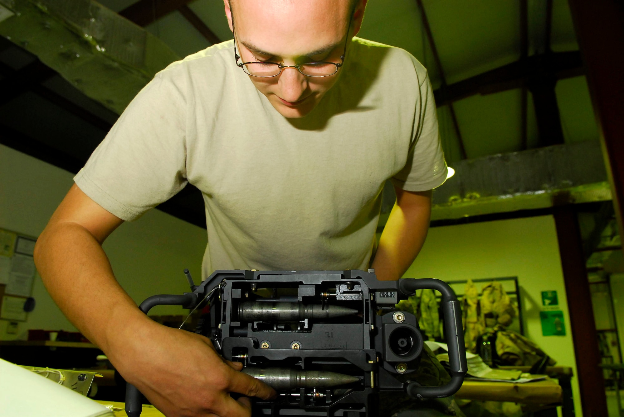 Senior Airman Brandon Dutton performs a round fixture test for a universal ammunition loader system Dec. 28 at Balad Air Base, Iraq. The UALS is the munitions loading interface that loads rounds into an F-16 Fighting Falcon. Airman Dutton, a 332nd Expeditionary Maintenance Squadron armament systems technician, is deployed from Luke Air Force Base, Ariz. (U.S. Air Force photo/Staff Sgt. Joshua Garcia) 
