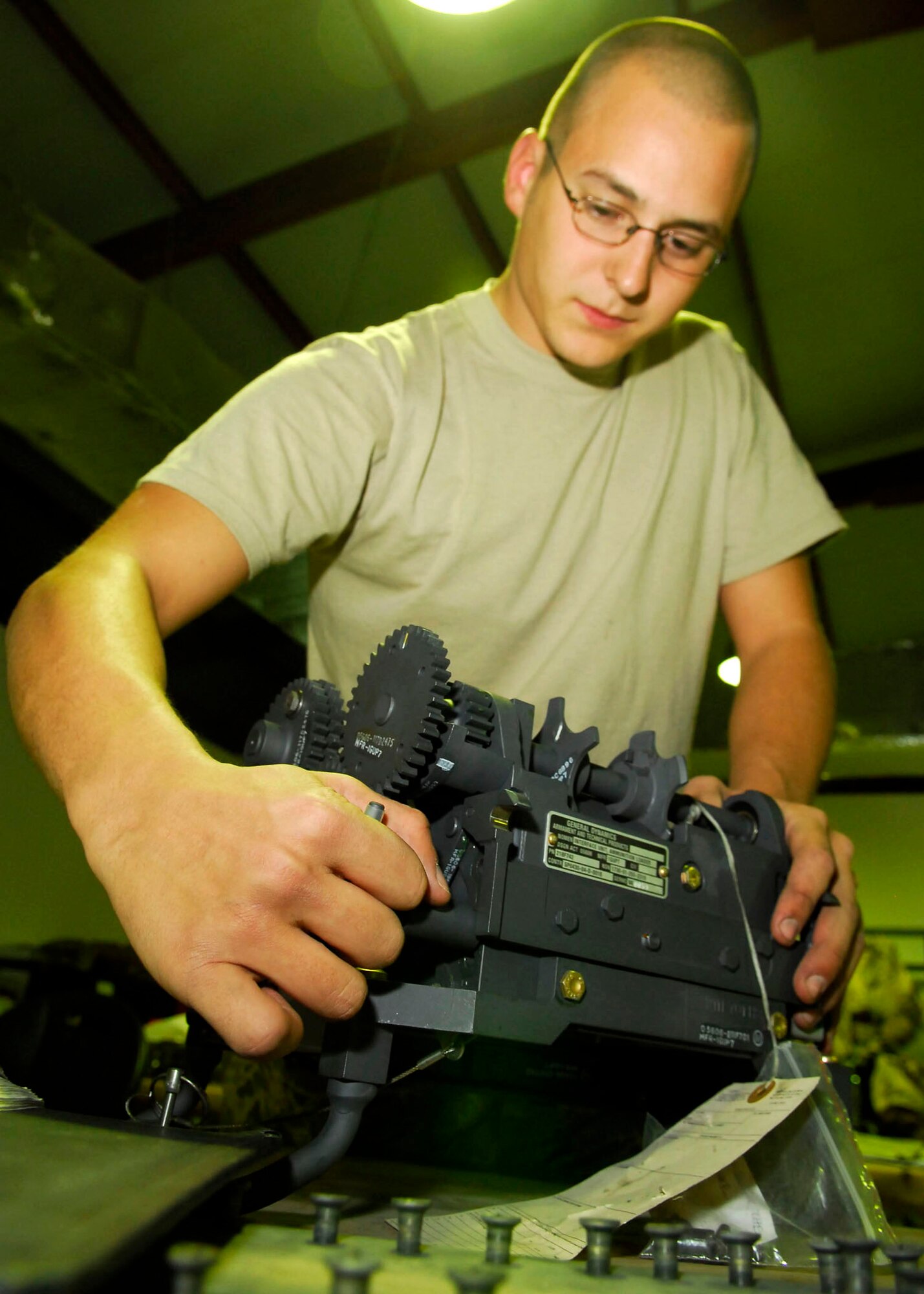 Senior Airman Brandon Dutton inspects a Universal Ammunition Loader System Dec. 28 at Balad Air Base, Iraq. Inspections on the UALS ensure they function within specifications. Airman Dutton, a 332nd Expeditionary Maintenance Squadron armament systems technician, is deployed from Luke Air Force Base, Ariz. (U.S. Air Force photo/Staff Sgt. Joshua Garcia) 
