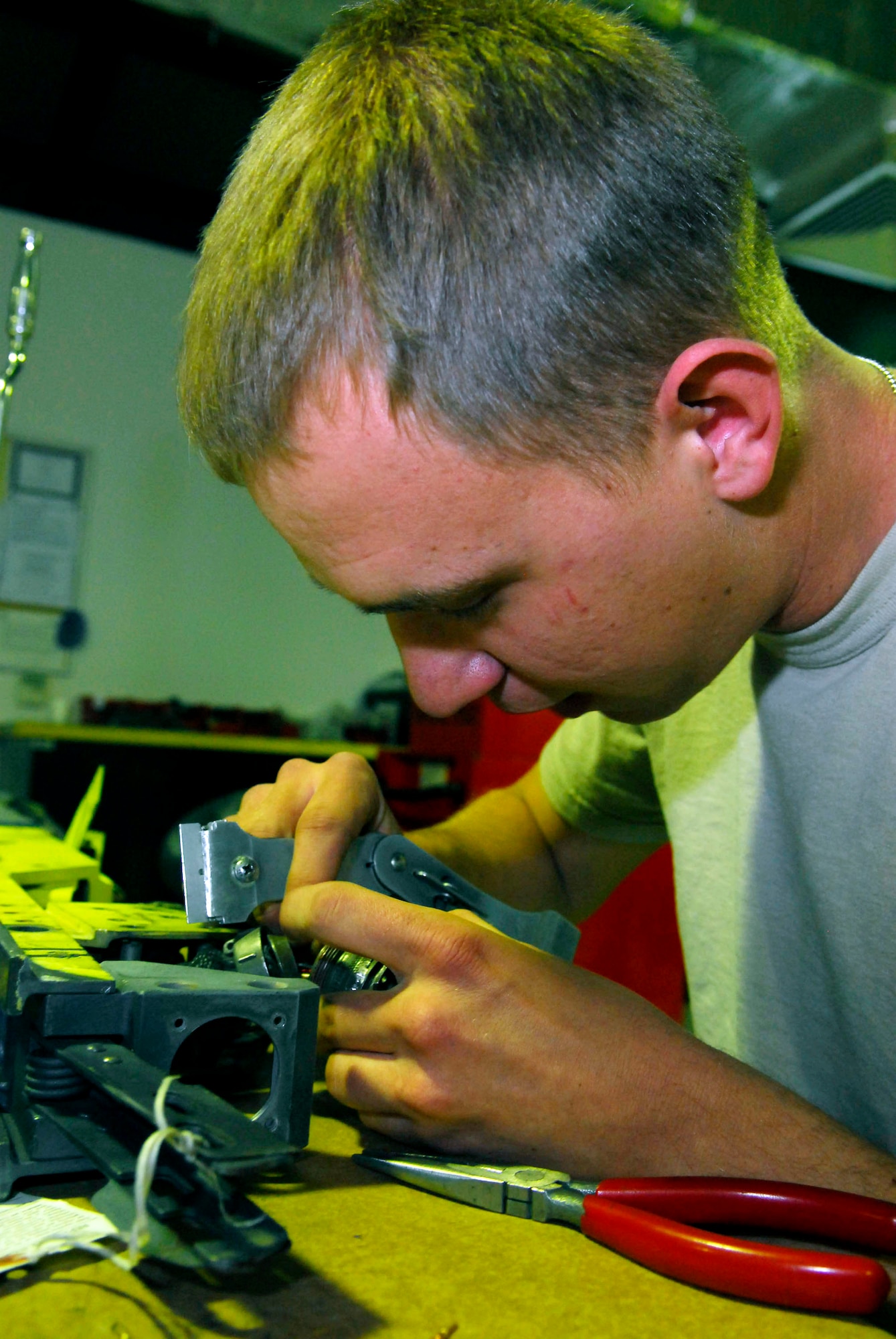 Airman 1st Class Chris Puzan repairs the electrical connector of a S2-10 missile launcher for the F-16 Fighting Falcon Dec. 28 at Balad Air Base, Iraq. The electrical connector is the interface between the launcher and the missile itself. Airman Puzan, a 332nd Expeditionary Maintenance Squadron armament systems technician, is deployed from Spangdahlem Air Base, Germany. (U.S. Air Force photo/Staff Sgt. Joshua Garcia) 
