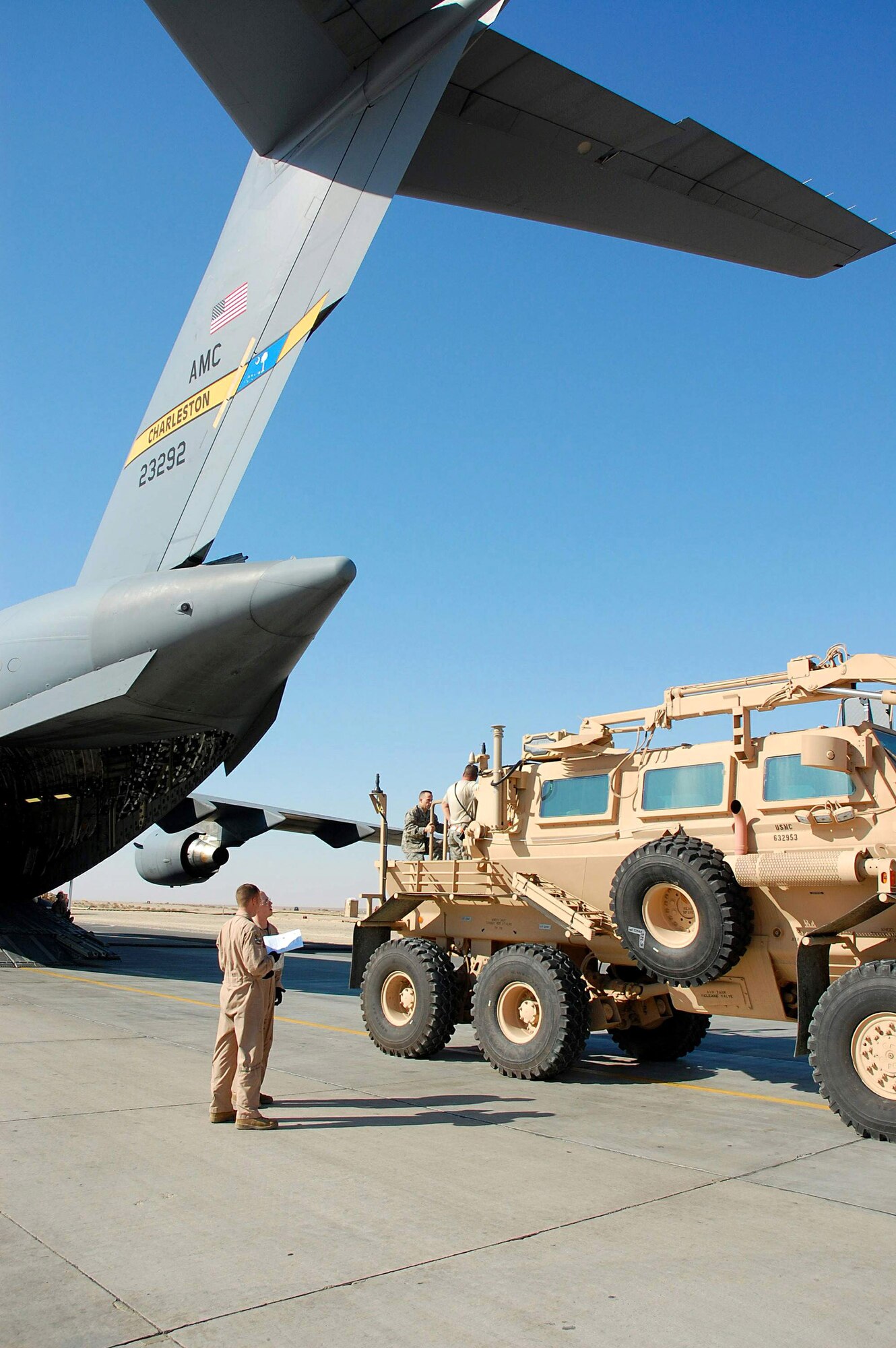 Airmen from the 386th and 379th Air Expeditionary Wings load a mine resistant ambush protected vehicle onto a C-17 Globemaster III from Charleston Air Force Base, S.C., Dec. 28 in Southwest Asia. The MRAP was heading to Iraq and is designed to help protect military members from mines and improvised explosive devices. The C-17's aircrew members are from McGuire AFB, N.J., and currently deployed to an air base in the Middle East. (U.S. Air Force photo/Staff Sgt. Tia Schroeder) 

