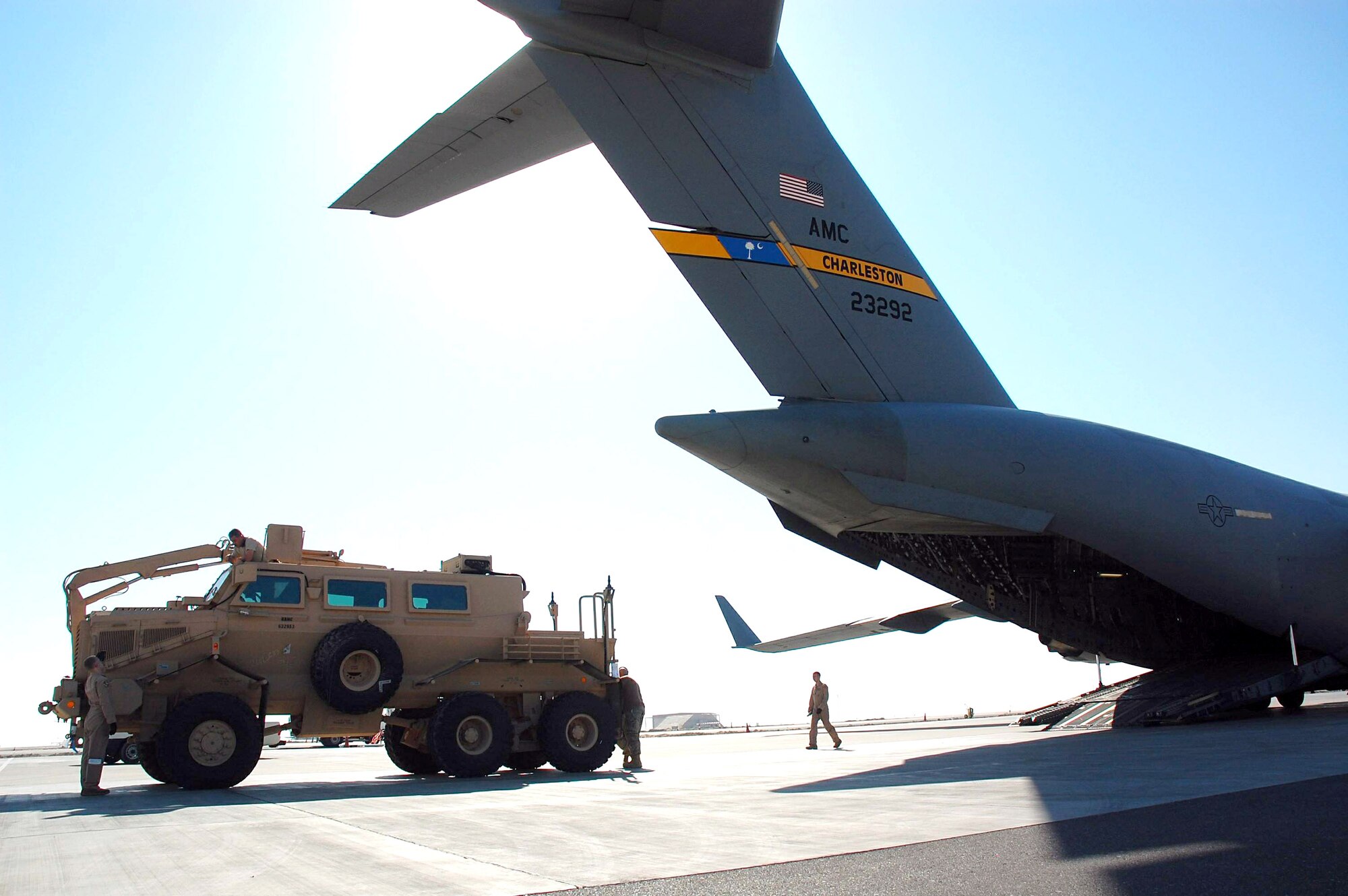 Airmen from the 386th and 379th Air Expeditionary Wings load a mine resistant ambush protected vehicle onto a C-17 Globemaster III from Charleston Air Force Base, S.C., Dec. 28 in Southwest Asia. The MRAP was heading to Iraq and is designed to help protect military members from mines and improvised explosive devices. The C-17's aircrew members are from McGuire AFB, N.J., and currently deployed to an air base in the Middle East. (U.S. Air Force photo/Staff Sgt. Tia Schroeder) 

