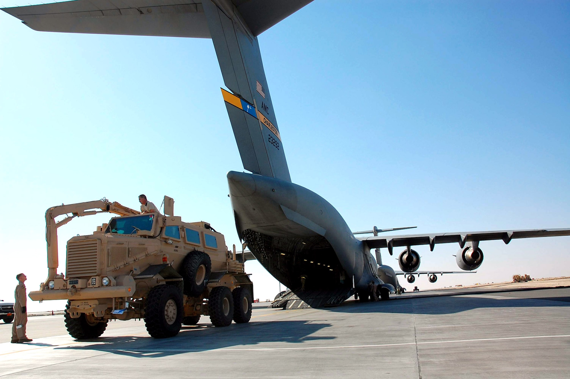 Airmen from the 386th and 379th Air Expeditionary Wings load a mine resistant ambush protected vehicle onto a C-17 Globemaster III from Charleston Air Force Base, S.C., Dec. 28 in Southwest Asia. The MRAP was heading to Iraq and is designed to help protect military members from mines and improvised explosive devices. The C-17's aircrew members are from McGuire AFB, N.J., and currently deployed to an air base in the Middle East. (U.S. Air Force photo/Staff Sgt. Tia Schroeder) 
