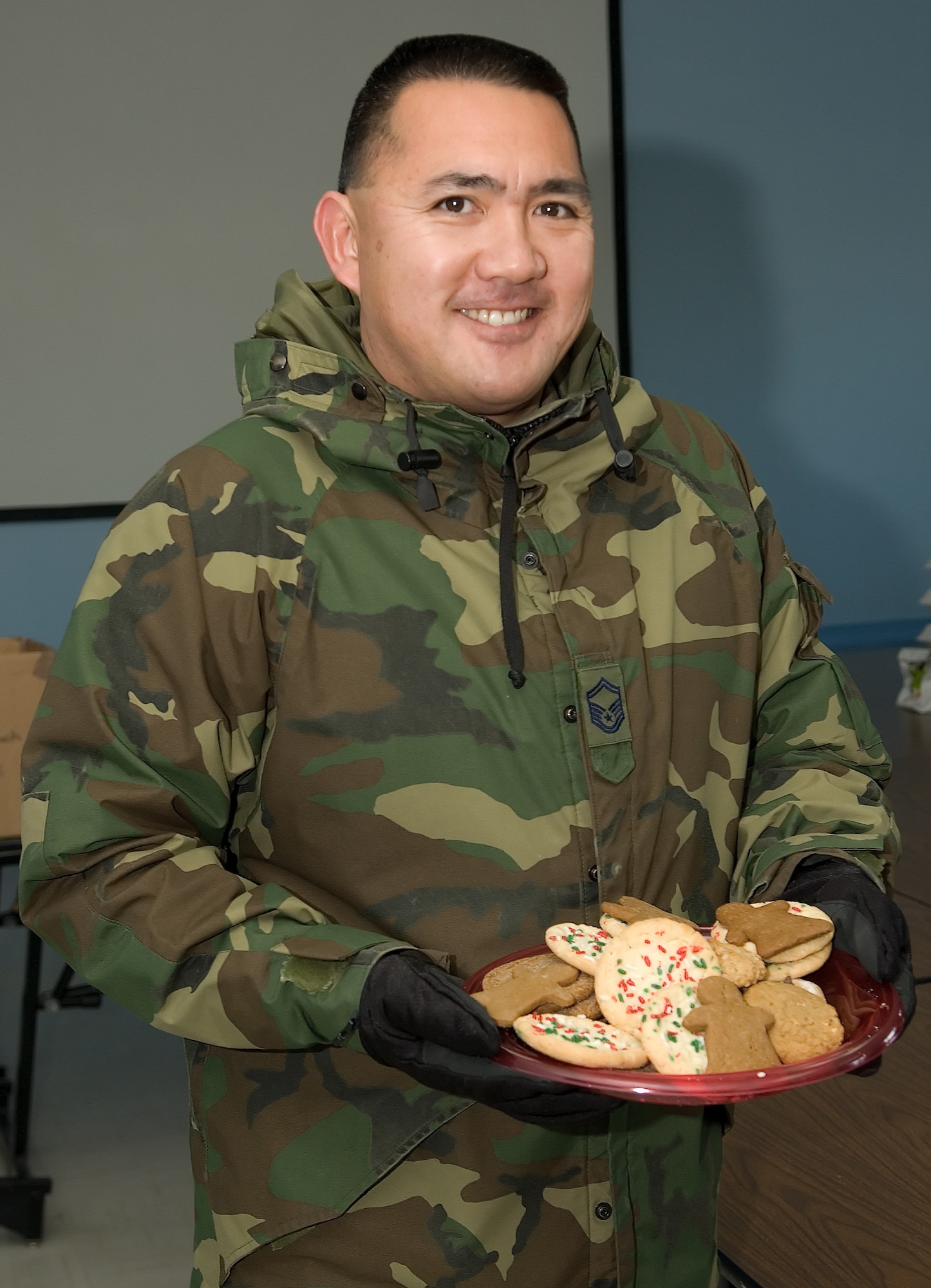 Senior Master Sgt. Randall Nonaka, 436th Mission Support Squadron, holds a plate of cookies during Operation Cookie Drop, Dec. 17. (U.S. Air Force photo/Jason Minto)