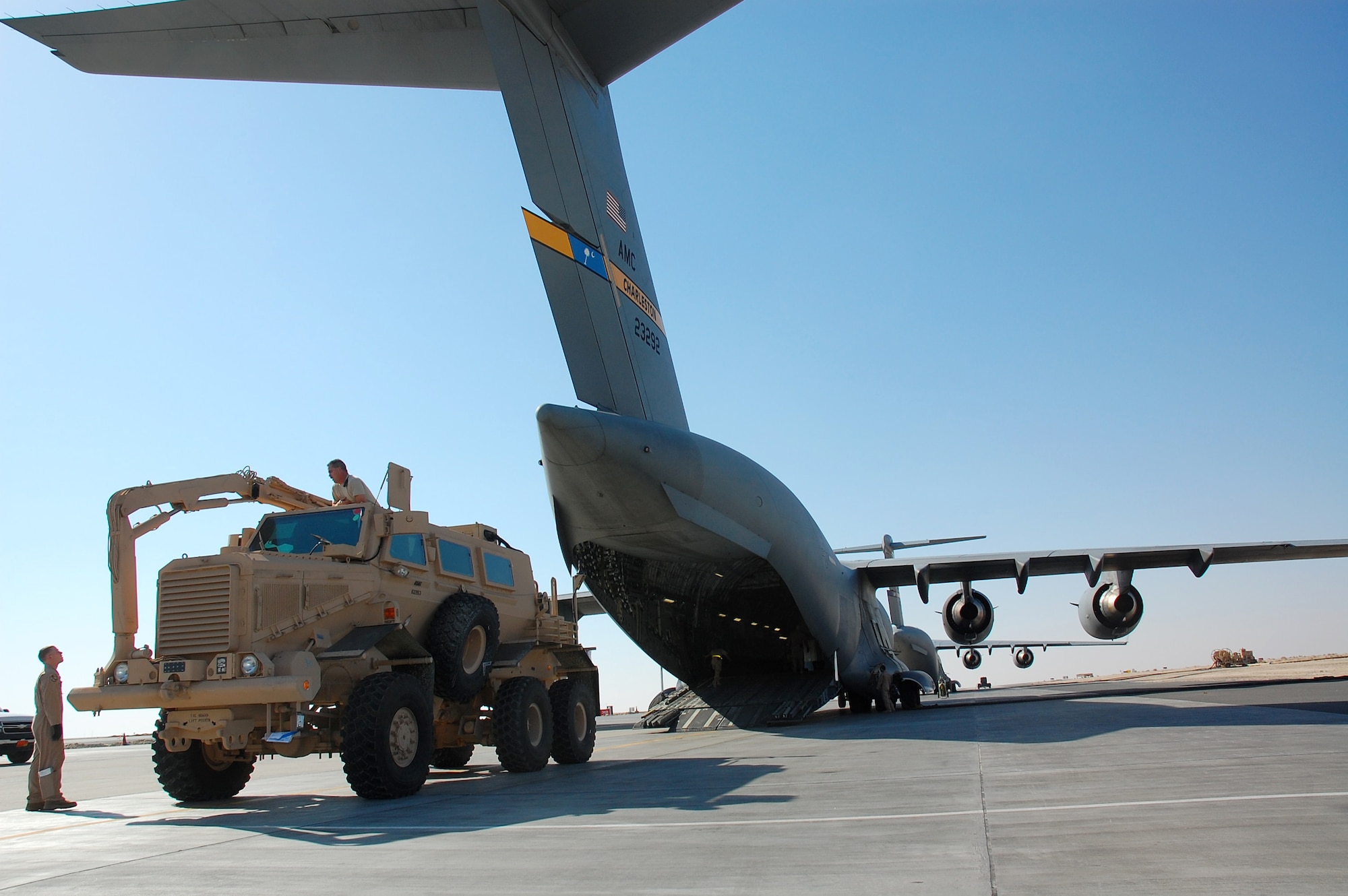 SOUTHWEST ASIA -- Airmen from the 386th and 379th Air Expeditionary Wings load a Mine Resistant Ambush Protected vehicle onto a C-17 Globemaster III from Charleston AFB, S.C., Dec. 28.  The MRAP was heading to Iraq and is designed to help protect military members from mines and improvised explosive devices.  The C-17's aircrew members are from McGuire AFB, N.J. and currently deployed to an air base in the Middle East.  (U.S. Air Force photo/Staff Sgt. Tia Schroeder)