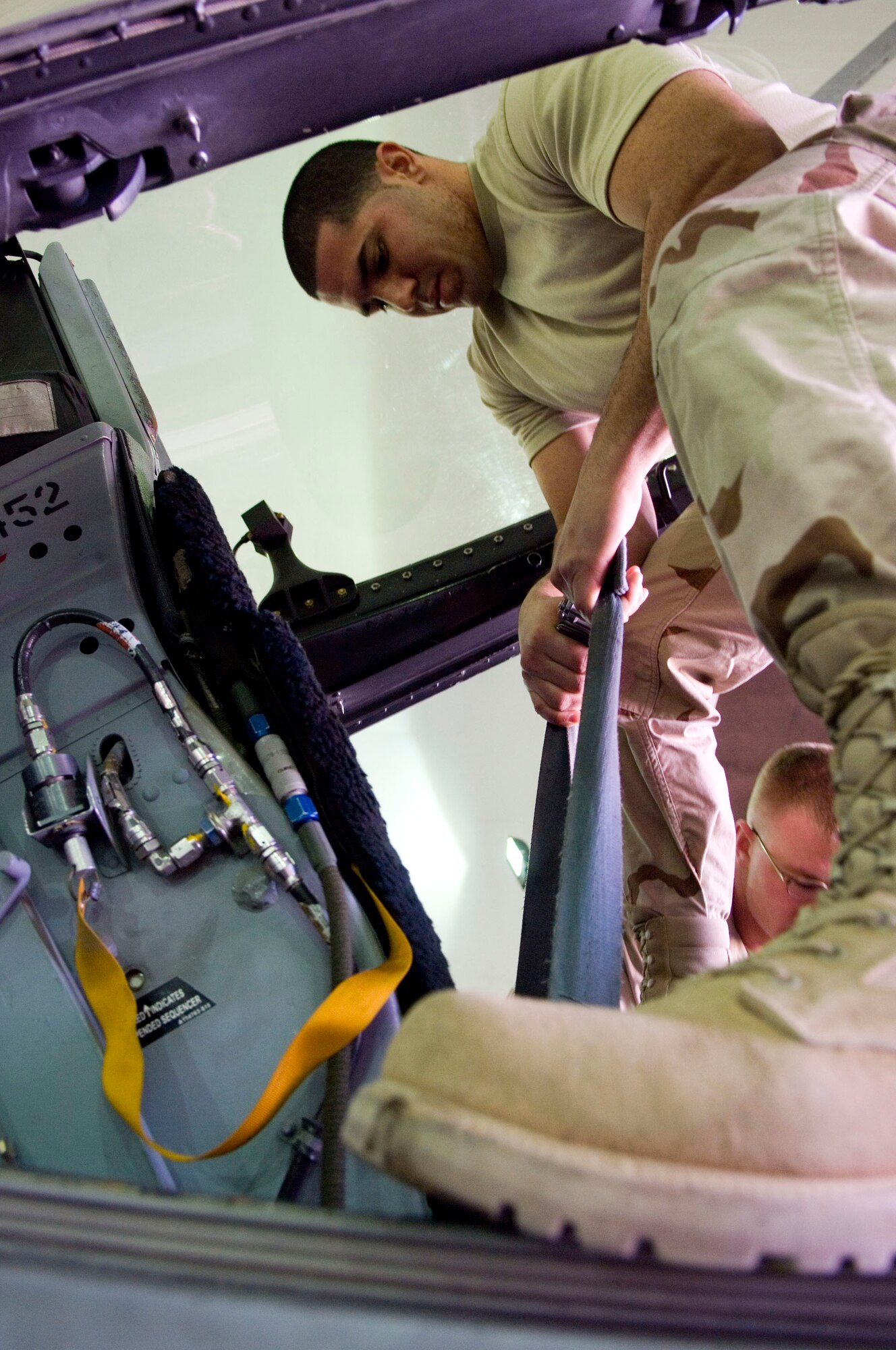 BALAD AIR BASE, Iraq -- Senior Airman Ulises Varela, a 332nd Expeditionary Maintenance Squadron aircrew egress technician, raises the ejection seat of an F-16 Fighting Falcon here, Dec. 28. The pilot’s ejection seat is raised during phase inspections to check for foreign object debris. Airman Varela is deployed from Hill Air Force Base, Utah. (U.S. Air Force photo/Staff Sgt. Travis Edwards)