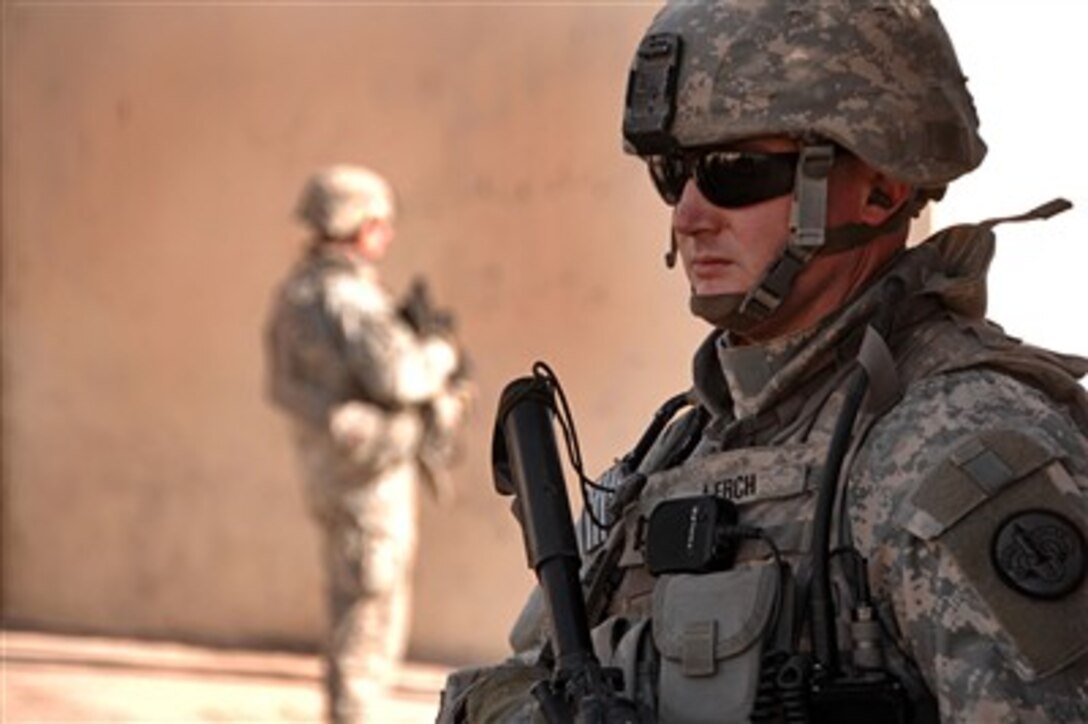 U.S. Army Capt. Mathew Lerch stands guard during a patrol in Mosul, Iraq, on Dec. 16, 2007.  Lerch and other soldiers of the 2nd Division Military Transition Team are working side-by-side with the Iraqi Army to assist and advise them on the fight against the insurgency. 