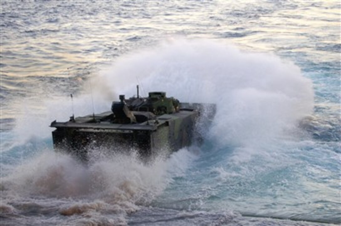 A U.S. Marine Corps Expeditionary Fighting Vehicle makes a splash as it departs the well deck of San Antonio class amphibious transport dock USS New Orleans (LPD 18) on Dec. 15, 2007.  