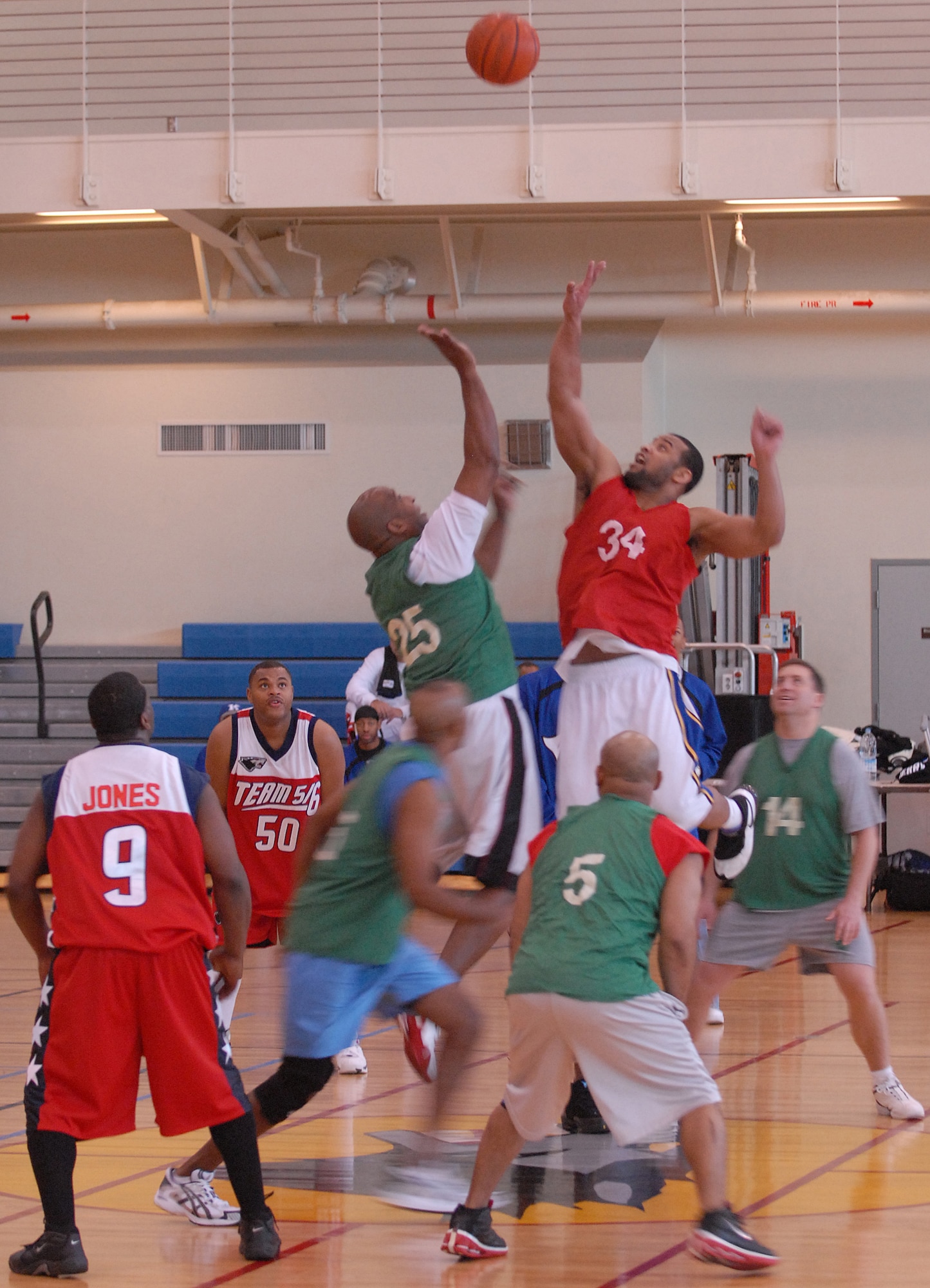 KUNSAN AIR BASE, South Korea -- Teams Top-Three (green) and 5/6 (red) compete during the Kunsan Celebrity Basketball Tournament here Dec. 29. The tournament is an event held to help raise funds for the men’s and women’s varsity basketball teams, boost morale, and encourage friendly sports competition during the holiday season. (U.S. Air Force photo/Senior Airman Giang Nguyen)