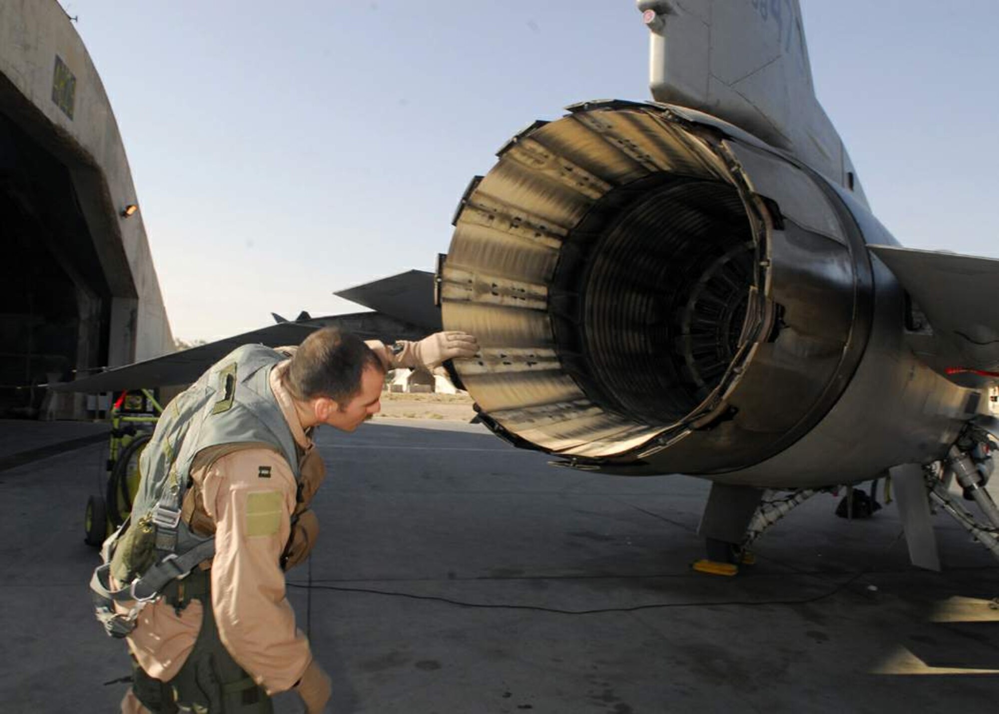 Capt. Thomas Graham inspects the exhaust system of an F-16 Fighting Falcon during a preflight inspection at Balad Air Base, Iraq. The exterior and interior of the aircraft are examined to ensure that everything is operating properly before flying missions in support of Operation Iraqi Freedom. Captain Thomas is assigned to the 4th Expeditionary Fighter Squadron. (U.S. Air Force photo/Staff Sgt. Joshua Garcia) 
