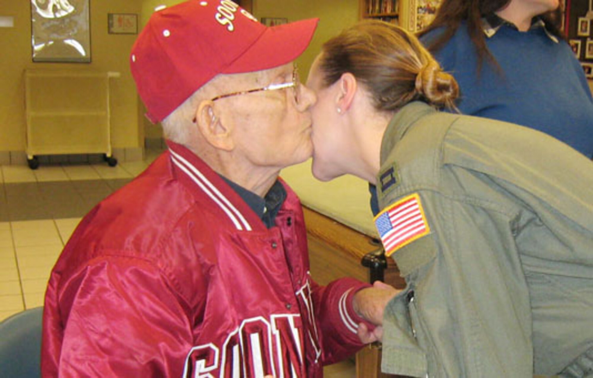 The picture captures the moment.  The residents of the Norman, Oklahoma, Veteran's Center appreciate receiving visits from wing reservists.  Here, Capt. Katrina Hightower receives a special kiss from one of the residents during the Center's Christmas party last month.  Dozens of reservists, civil service workers and other participants helped to make this year's Angel Tree Christmas gift program a success.  