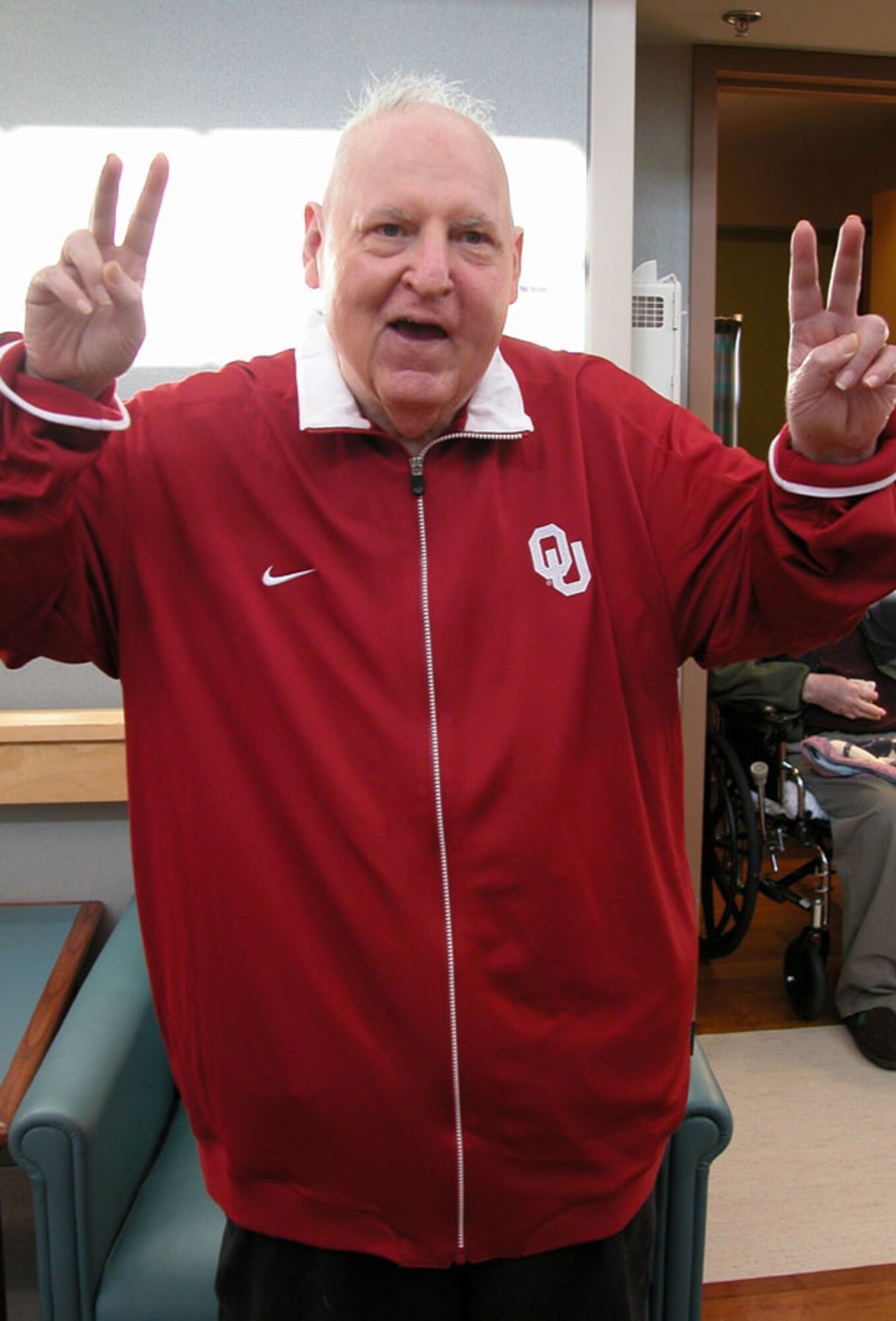 Bill C., a Norman Veteran Center resident and former Navy man, shows his Sooner spirit after trying on his special Christmas gift.  Some gifts are hard to find but this one was donated by Oklahoma University's Athletic Department.  Unit members go to great lengths to fill the wishes of the veterans.