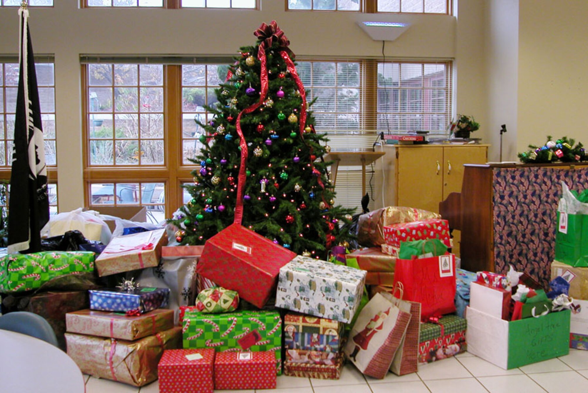 Christmas gifts surround one of several Christmas trees at the Norman, Oklahoma, Veteran's Center.  A total of 294 presents were gathered and donated by Air Force Reserve members and other friends stationed at Tinker Air Force base to present to veterans living at the center.