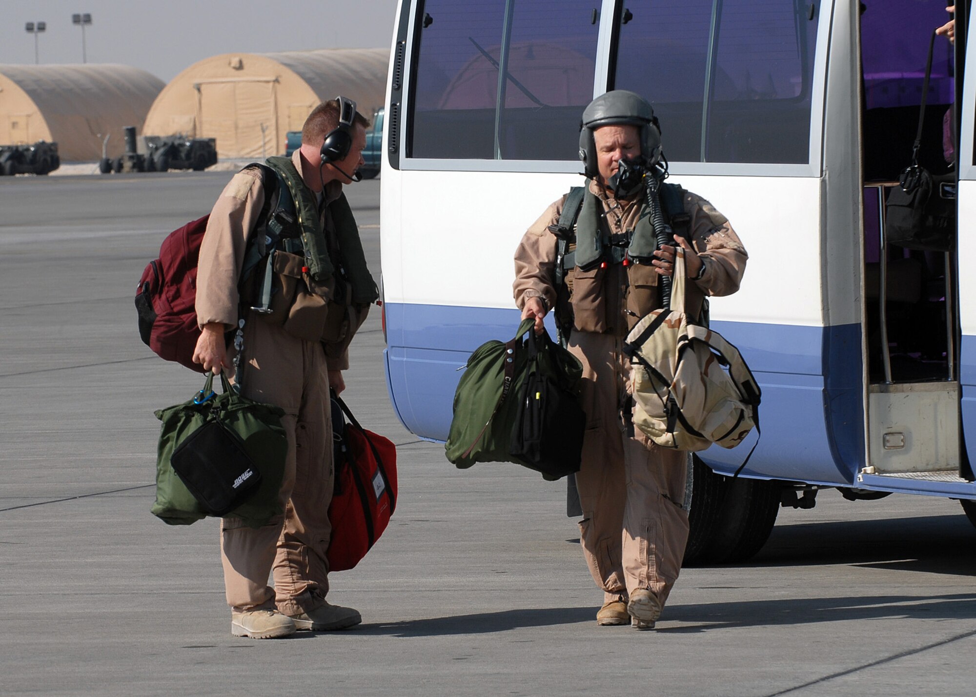 SOUTHWEST ASIA - 1st Lt. Thomas Walsh (left), 9th Expeditionary Bomb Squadron, and Brig. Gen. Charlie Lyon, 379th Air Expeditionary Wing commander, leave the crew bus to board a B-1B Lancer bomber for a mission at a Southwest Asia air base Dec. 29. (U. S. Air Force photo/Staff Sgt. Douglas Olsen)


