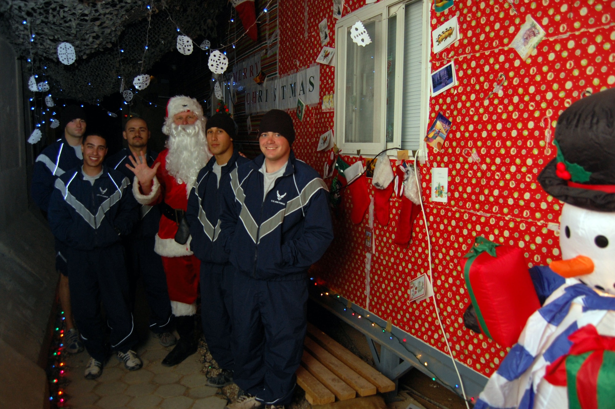 CAMP BUCCA, IRAQ -- Santa Claus stops by one of the dorm buildings the Airmen decorated Dec. 24 here. Some Airmen have gone to great lengths to decorate the dorms even as far as making chimneys for santa to come down. (Air Force photo\Staff Sgt. Phillip Butterfield) 