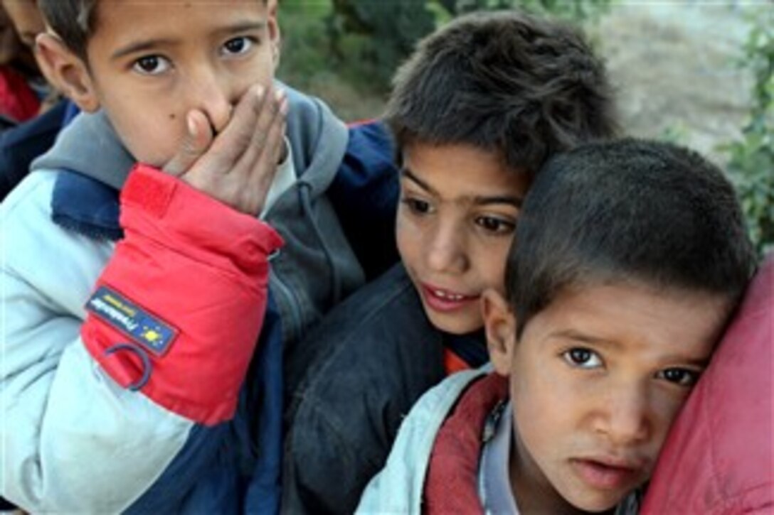 Children wait in line for food and supplies during a combined medical engagement with U.S. Army soldiers from the 7th Cavalry Regiment in Saqlawiyah, Iraq, Dec. 28, 2007.