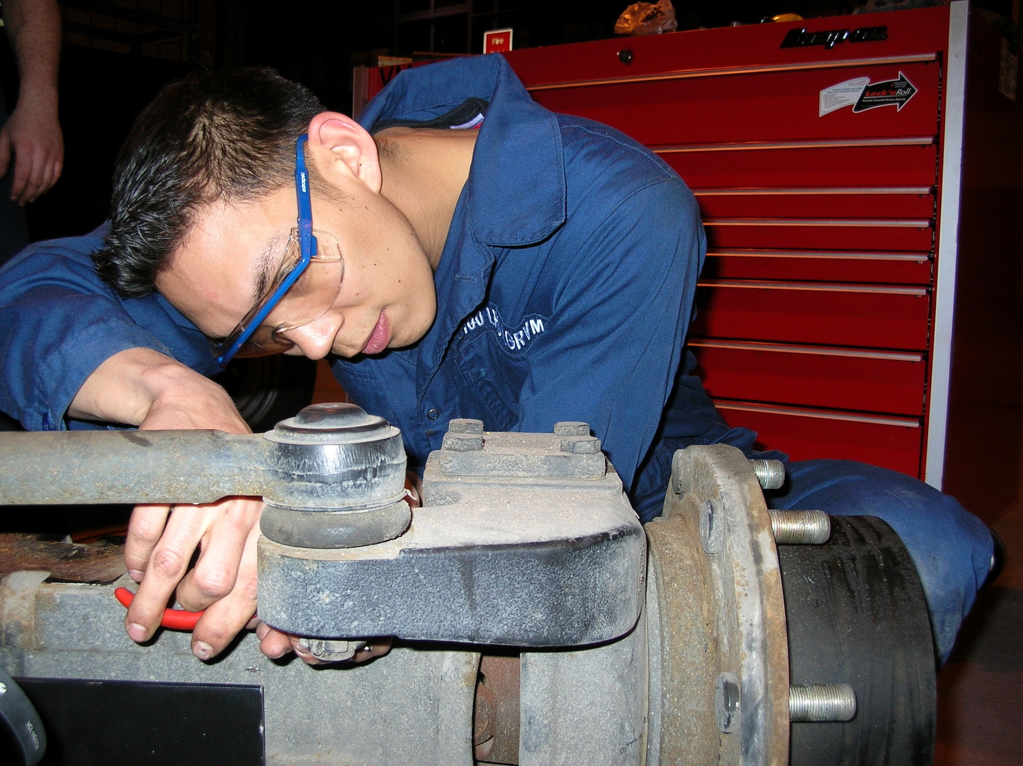 Staff Sgt. Lee Samson works on a 1,500-pound axle removed from an aircraft tow vehicle Feb. 1 at Royal Air Force Mildenhall, England. He is perfecting an Air Force Smart Operations for the 21st Century initiative to improve the procedures for removing and working on the axle. Sergeant Samson is a vehicle mechanic with the 100th Logistics Readiness Squadron. (U.S. Air Force photo/Tech. Sgt. Scott Wakefield) 