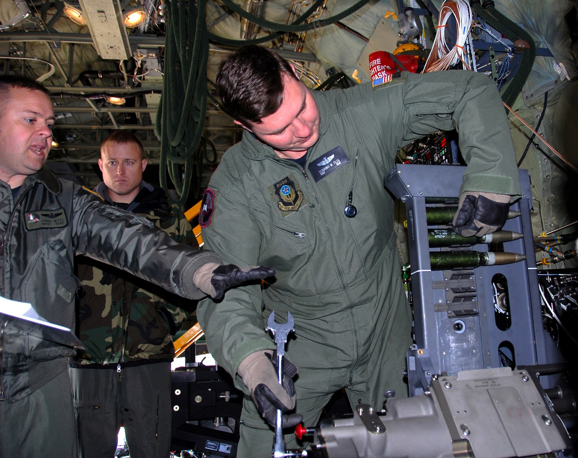 Master Sgt. Chris Jette explains loading procedures for a 30mm Bushmaster cannon for an AC-130U Spooky gunship to Tech. Sgt. Ben Filek while Tech. Sgt. James Knight looks on Jan. 26 at Hurlburt Field, Fla. The 30 mm gun will eventually replace both the 40 mm cannon and 25 mm gun on U-model gunships. Sergeant Jette is an aerial gunner with the 1st Special Operations Group standardization/evaluation section at Hurlburt Field, Sergeants Filek and Knight are aerial gunners with the 19th Special Operations Squadron at Hurlburt. (U.S. Air Force photo/Chief Master Sgt. Gary Emery)