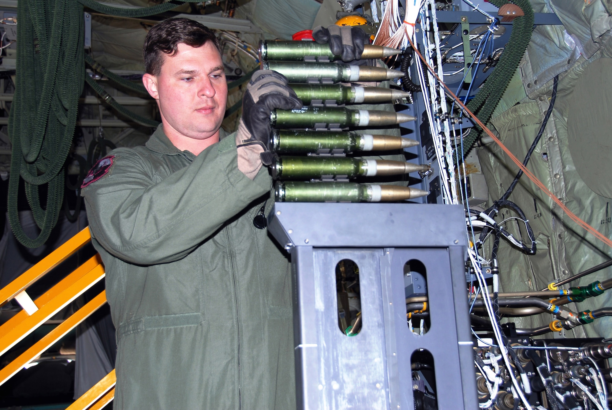 Tech. Sgt. Ben Filek practices loading a 30 mm Bushmaster cannon aboard an AC-130U Spooky gunship Jan. 26 at Hurlburt Field, Fla. The 30 mm gun will eventually replace both the 40 mm cannon and 25 mm gun on U-model gunships. Sergeant Filek is an aerial gunner with the 19th Special Operations Squadron at Hurlburt Field. (U.S. Air Force photo/Chief Master Sgt. Gary Emery)