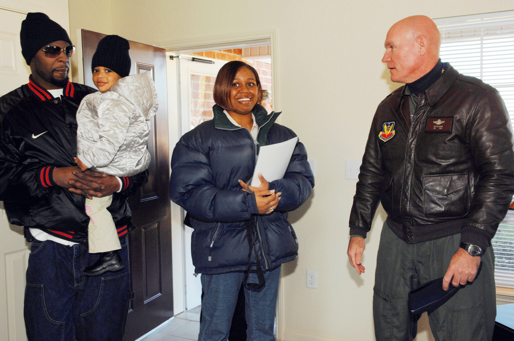 Col. Joe Callahan, 23rd Wing commander, shows Staff Sgt. Jessica Davis, 347th Operations Support Squadron, and her husband Calvin, their new base housing unit.  The 2,100 square-foot home is the first of 383 units to be built in Moody’s Magnolia Grove Housing area between now and December 2007. (U.S. Air Force photo by Airman 1st Class Gina Chiaverotti)  
