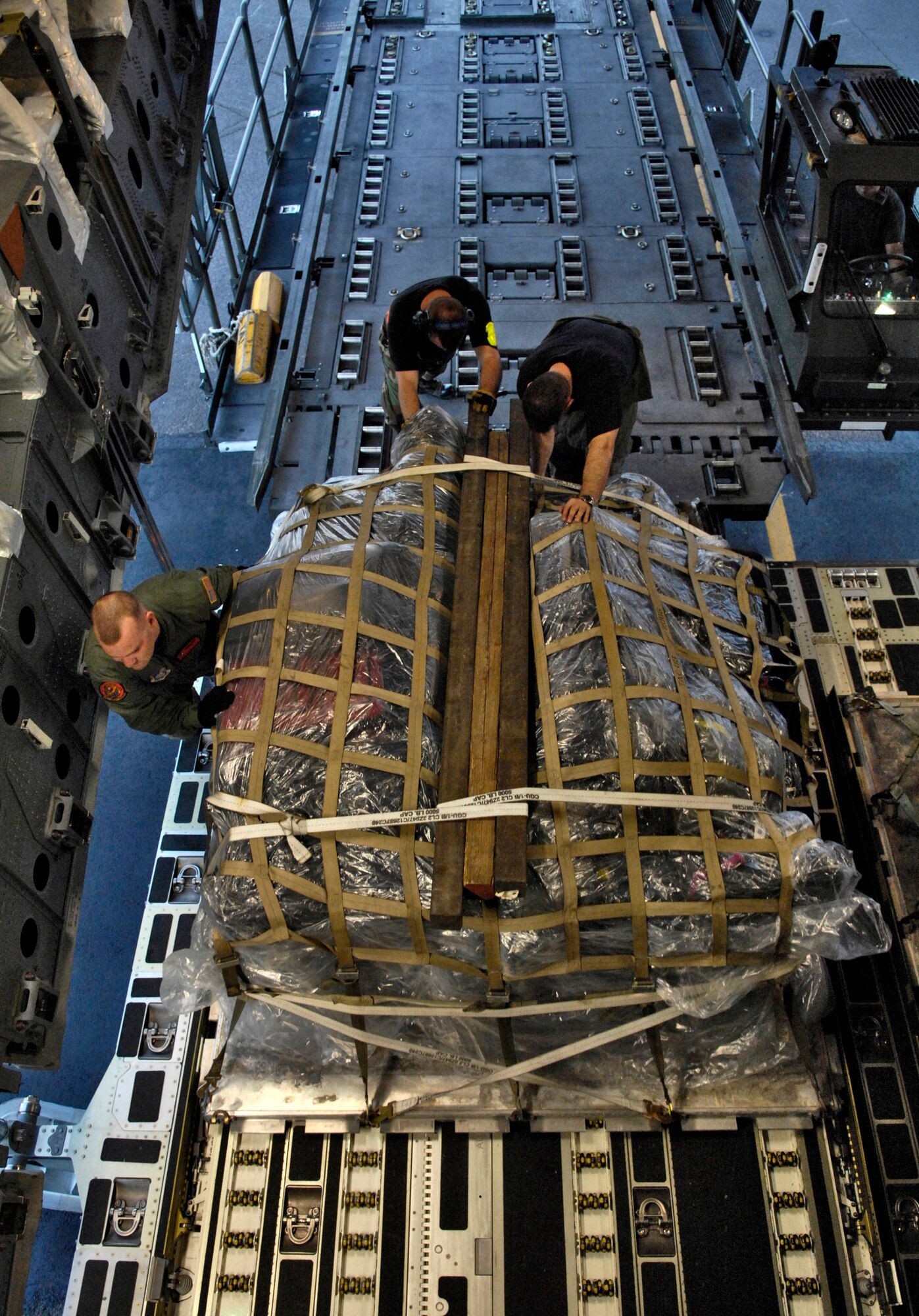 0Staff Sgt. Jason Scaffidi helps load a pallet onto a C-17 Globemaster III Jan. 25 at Hickam Air Force Base, Hawaii. Sergeant Scaffidi is a loadmaster with the 535th Airlift Squadron. The C-17 can take off and land on runways as short as 3,500 feet and only 90 feet wide. Even on such narrow runways, the C-17 can turn around using a three-point star turn and its backing capability. (U.S. Air Force photo/Tech. Sgt. Shane A. Cuomo) 
