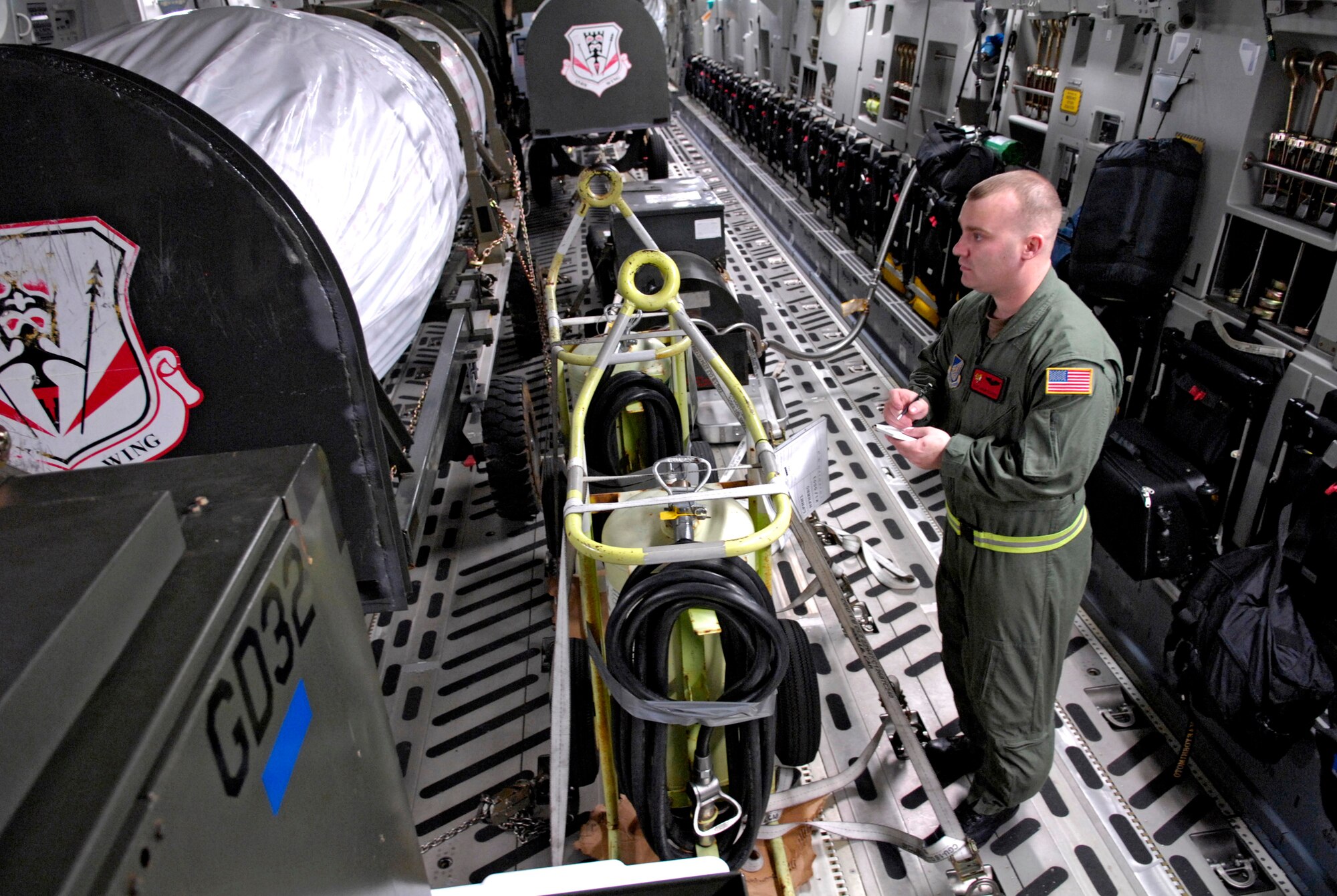 Staff Sgt. Jason Scaffidi writes down positions and weights of equipment on a C-17 Globemaster III Jan. 25 at Hickam Air Force Base, Hawaii. Sergeant Scaffidi is a loadmaster with the 535th Airlift Squadron. The aircraft can perform tactical airlift and airdrop missions and can also transport litters and ambulatory patients during aeromedical evacuations when required. (U.S. Air Force photo/Tech. Sgt. Shane A. Cuomo) 
