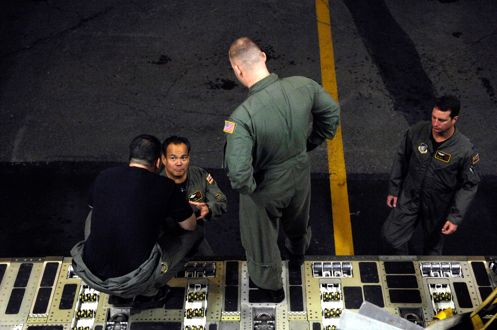 Staff Sgt. Jason Scaffidi talks with other C-17 Globemaster III crew members before departing for a mission Jan. 25 from Hickam Air Force Base, Hawaii. Sergeant Scaffidi is a loadmaster with the 535th Airlift Squadron. The C-17 Globemaster III is capable of rapid strategic delivery of troops and all types of cargo to main operating bases or directly to forward bases in the deployment area. (U.S. Air Force photo/Tech. Sgt. Shane A. Cuomo) 
