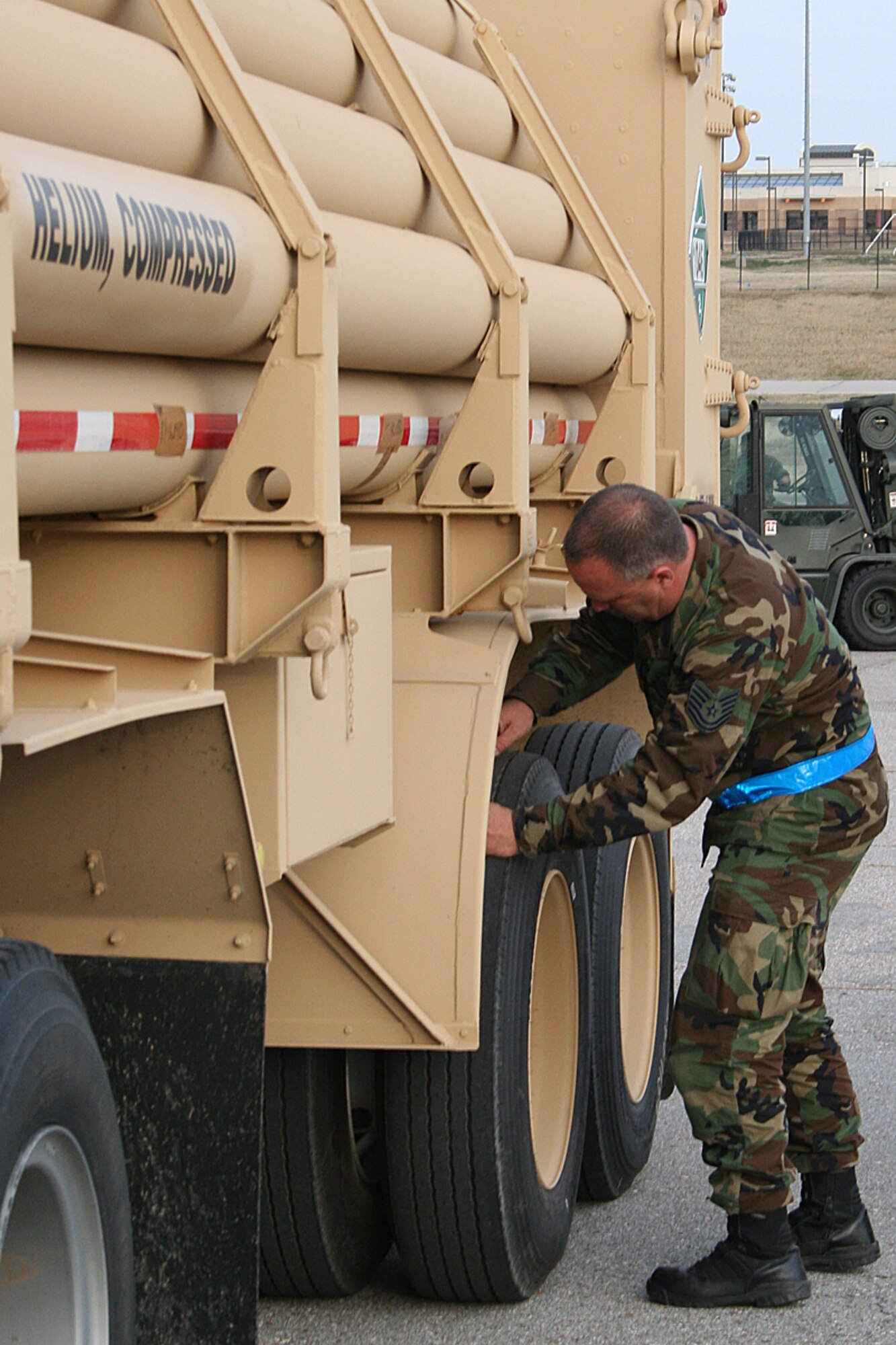 Tech. Sgt. Scott Alexander, 22nd Logistics Readiness Squadron, inspects the tire treads of a helium tank trailer prior to driving it on to the flightline Nov. 4, the day LRS Airmen loaded several tanks onto a C-17, from the 62nd Airlift Wing, McChord Air Force Base, Wash. The C-17 transported the tanks to Southwest Asia. Mission capability support functions such as this will fall under the supply chain management flight once the 22nd LRS finishes realigning its structure from seven flights to four. The new flights will include the supply chain management flight, the readiness flight, the fuels management flight and the vehicle and equipment management flight. (Photo by Petty Officer 2nd Class Troy Karr, 22nd ARW Public Affairs)