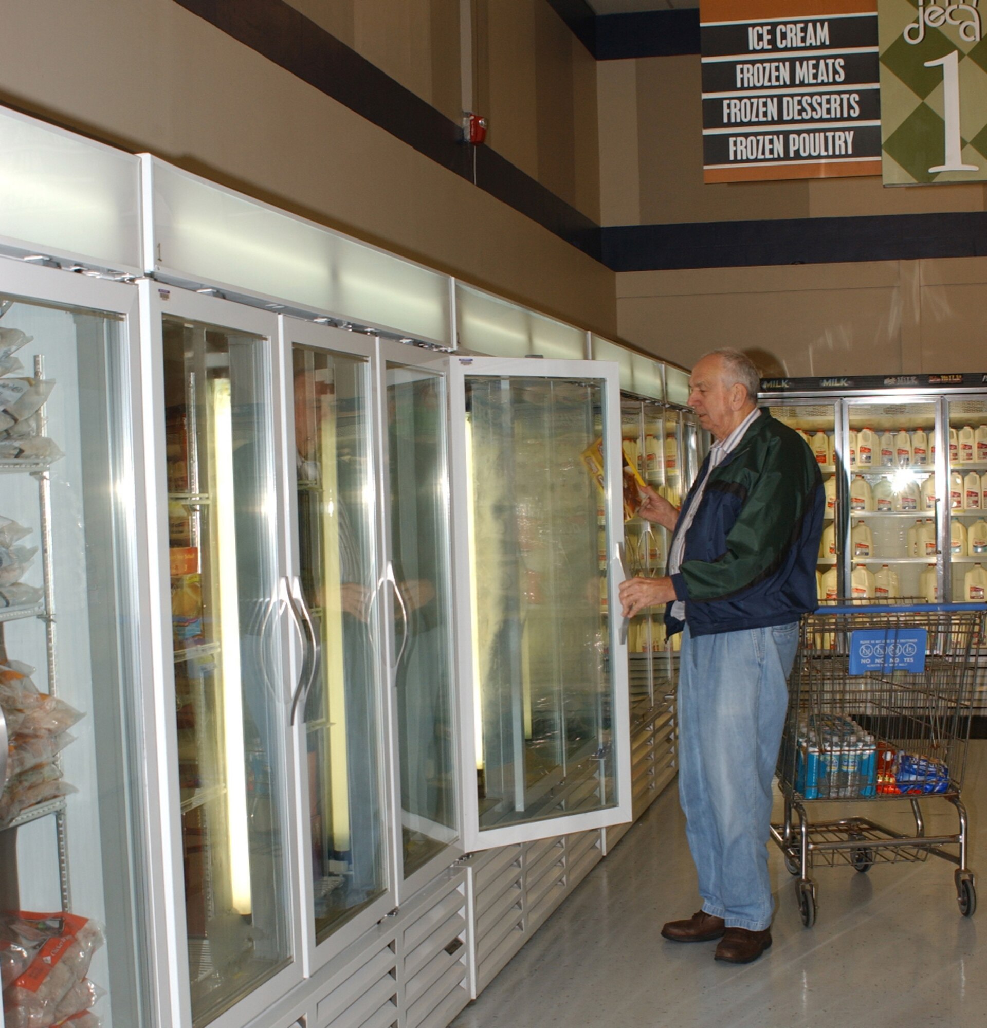 Charles Harrell, a retired lieutenant colonel from Moss Point, selects items from the new frozen food cases at the commissary.  (U.S. Air Force Photo by Kemberly Groue)