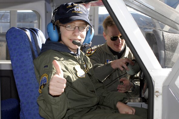 Zachery Olson, a 14-year-old suffering from neurofibromatosis, gets acquainted with a Civil Air Patrol aircraft Jan. 19. Olson got a flight in the CAP craft, toured a C-21 and was made an honorary pilot through the 311th Airlift Squadron and the Make-A-Wish Foundation. (U.S. Air Force photo by Larry Hulst)