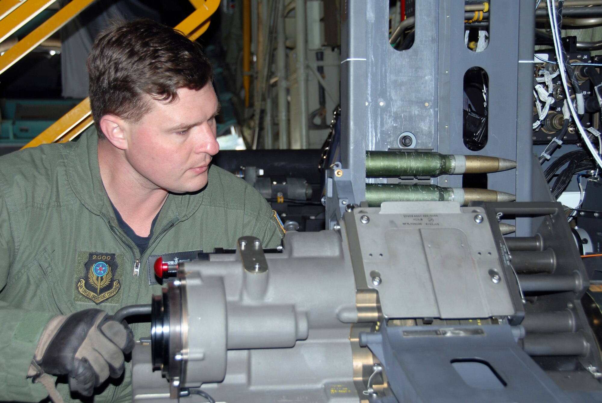 Technical Sgt. Ben Filek, an aerial gunner with the 19th Special Operations Squadron at Hurlburt Field, Fla., loads a 30 mm Bushmaster cannon aboard an AC-130U Spooky gunship.  The 30 mm gun will eventually replace both the 40 mm cannon and 25 mm gun on U-model gunships.  (Air Force photo by Chief Master Sgt. Gary Emery)