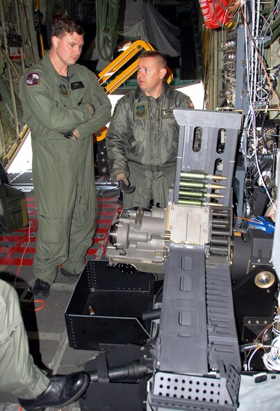 Technical Sgt. Ben Filek, left, and Master Sgt. Chris Jette look over a newly-installed 30 mm Bushmaster cannon aboard an AC-130U Spooky gunship. Sergeant Filek is an aerial gunner with the 19th Special Operations Squadron at Hurlburt Field, Fla.  Sergeant Jette, also an aerial gunner, is with the 1st Special Operations Group standardization/evaluation section at Hurlburt.  The 30 mm gun will eventually replace both the 40 mm cannon and 25 mm gun on U-model gunships.  (Air Force photo by Chief Master Sgt. Gary Emery)