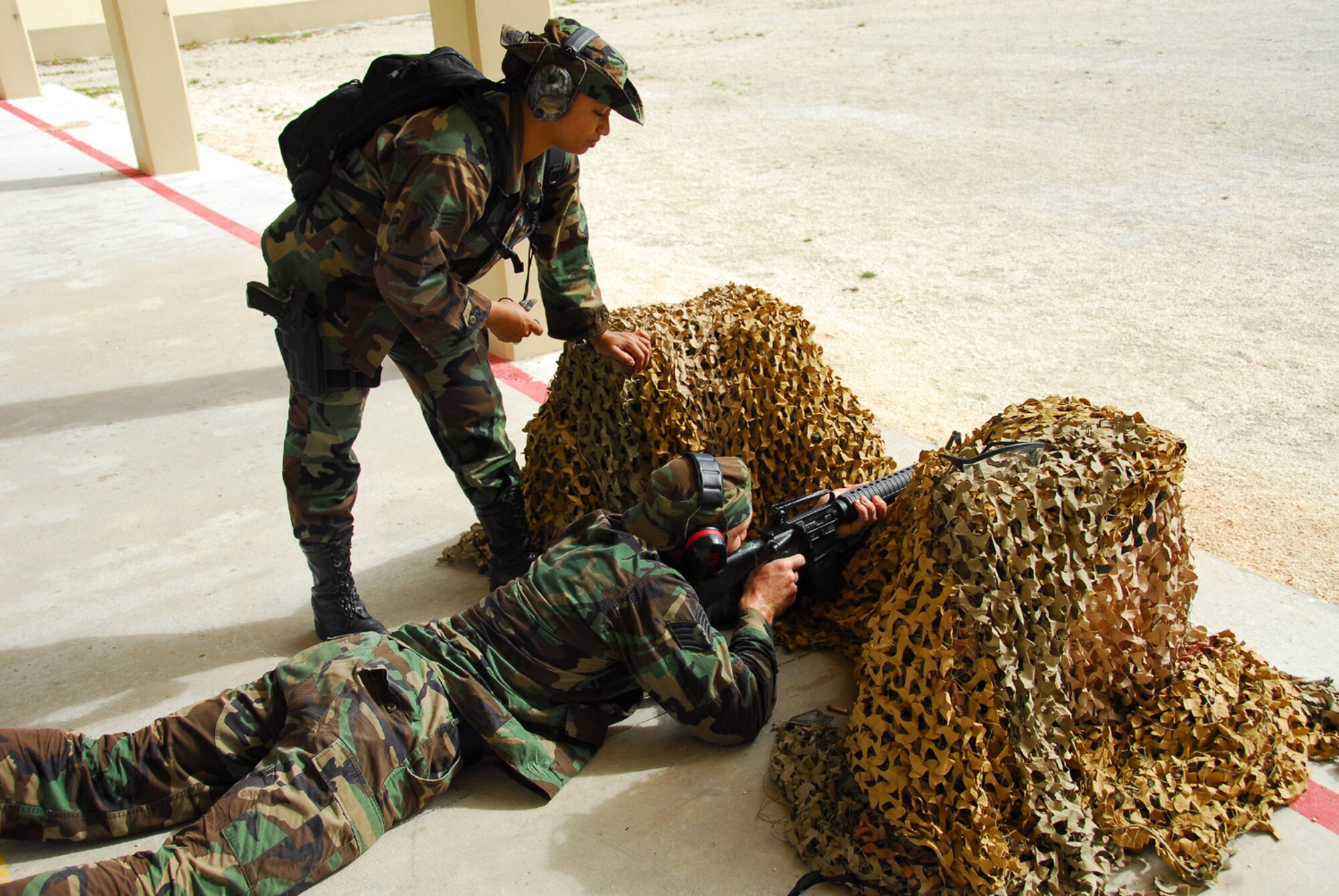 Staff Sgt. Brent Watkins fills in a defensive lining position to engage in live fire and take out the enemy at Checkpoint 5 during Warrior Day Jan. 26 at Andersen Air Force Base, Guam. Sergeant Watkins is assigned to the 36th Civil Engineer Squadron. The competition simulated challenges Airmen may face in combat. (U.S. Air Force photo/Tech. Sgt. Michael Boquette) 
