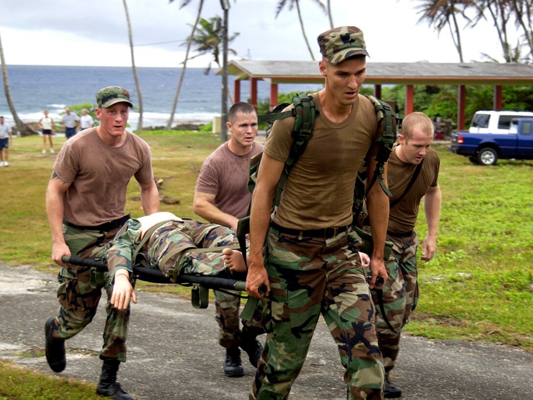 Senior Airman Kyle Altstaetter leads other members of the 36th Contingency Response Group team in carrying a critically wounded patient to the medical evacuation point during Warrior Day Jan. 26 at Checkpoint 4 at Andersen Air Force Base, Guam. Warrior Day is an annual competition on Andersen AFB to enhance Airmen's warfighting skills. (U.S. Air Force photo/Senior Airman Miranda Moorer) 
