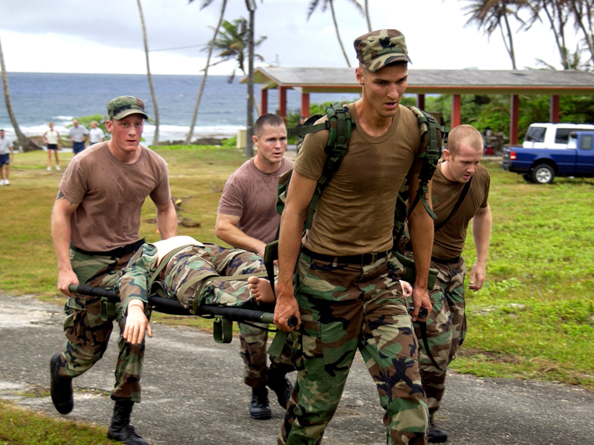 Senior Airman Kyle Altstaetter leads other members of the 36th Contingency Response Group team in carrying a critically wounded patient to the medical evacuation point during Warrior Day Jan. 26 at Checkpoint 4 at Andersen Air Force Base, Guam. Warrior Day is an annual competition on Andersen AFB to enhance Airmen's warfighting skills. (U.S. Air Force photo/Senior Airman Miranda Moorer) 
