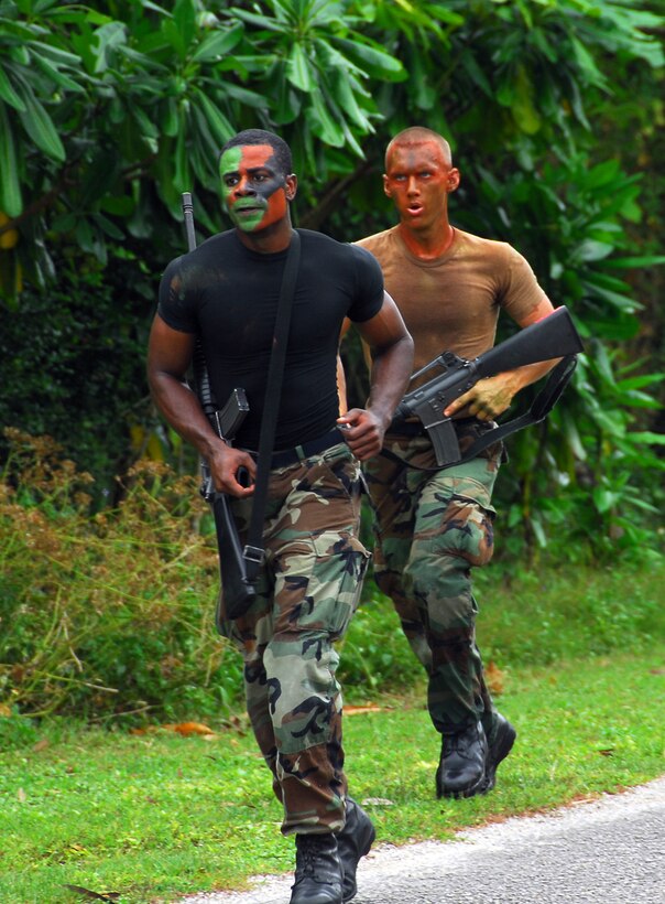 Staff Sgt. Christopher Berry (front) and Airman 1st Class Bryan Nagy, both from the 36th Communications Squadron, run 2.3 miles to Checkpoint 6 during the Warrior Day competition Jan. 25 at Andersen Air Force Base, Guam. The competition simulates challenges Airmen may face in combat. (U.S. Air Force photo/Tech. Sgt. Michael Boquette)
